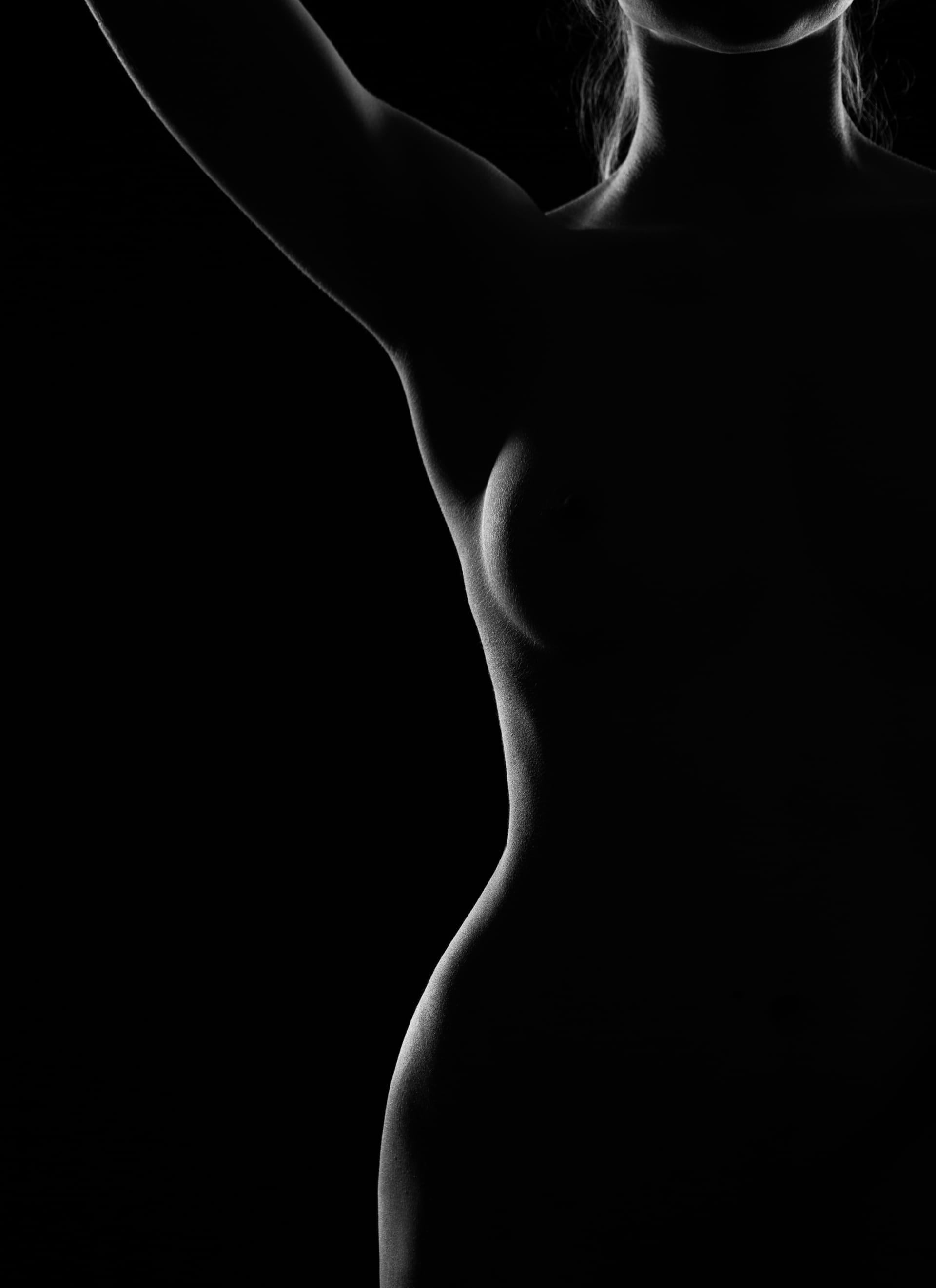 Black white photograph graceful nude female body contoured light