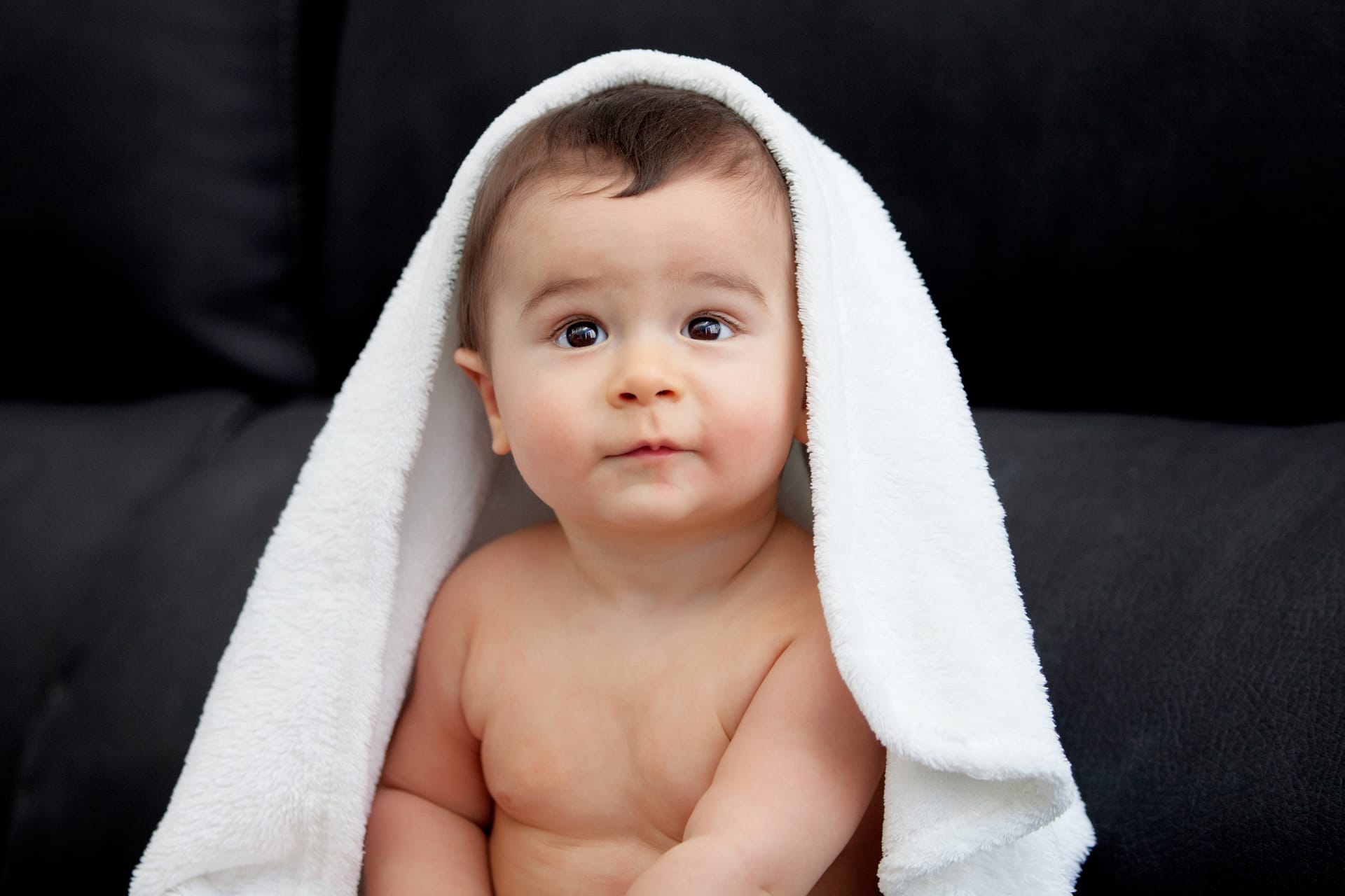 Baby photoshoot adorable baby covered with towel