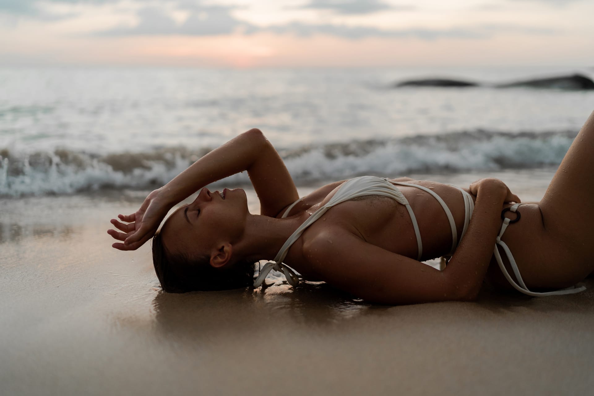 Blond woman lying summer beach perfect tann body sunset light