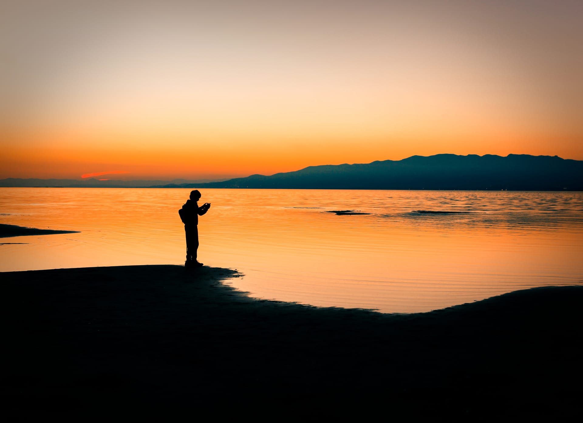 Silhouette man standing coastline sunset sky sea