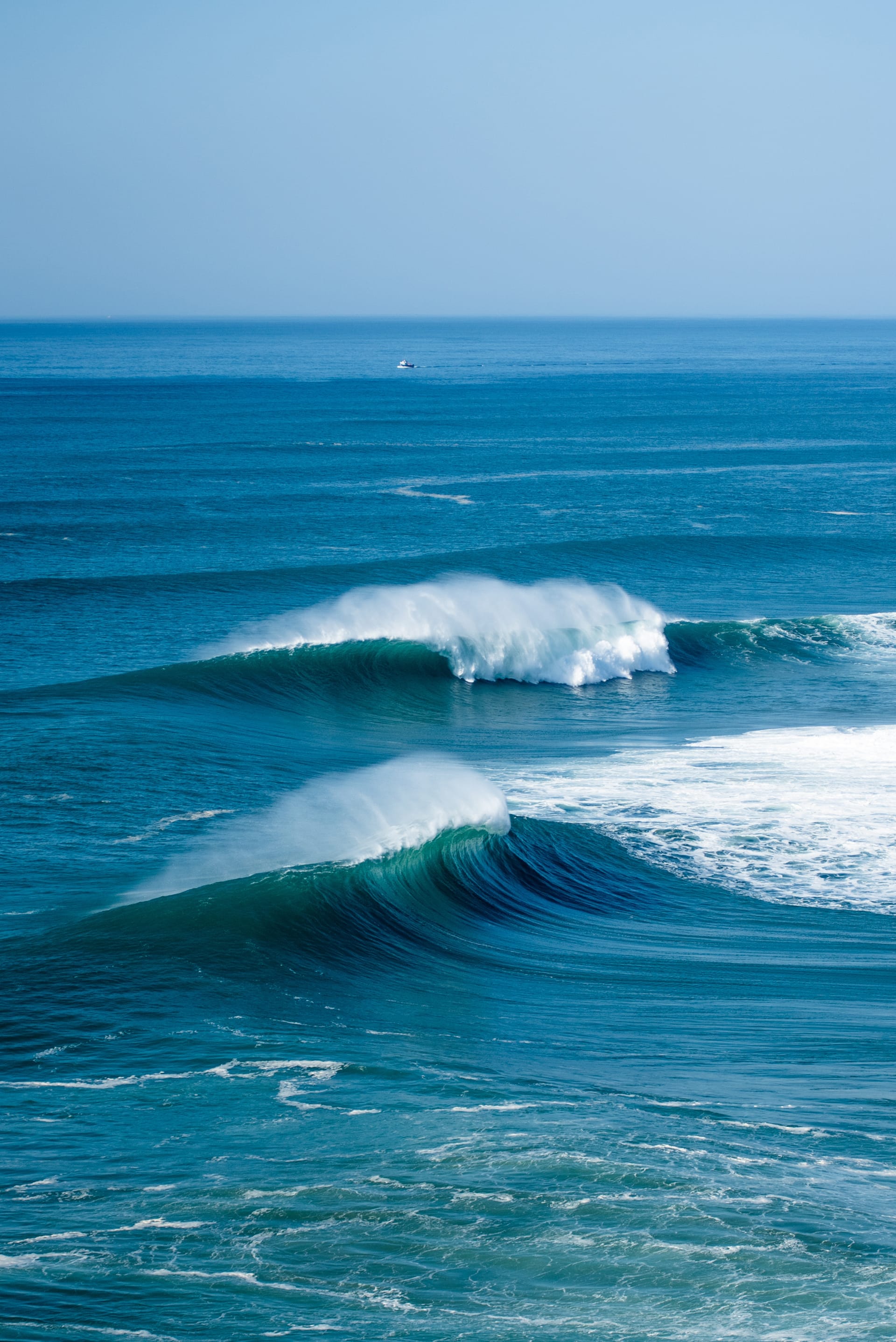 Vertical shot foamy waves atlantic ocean near nazare municipality portugal