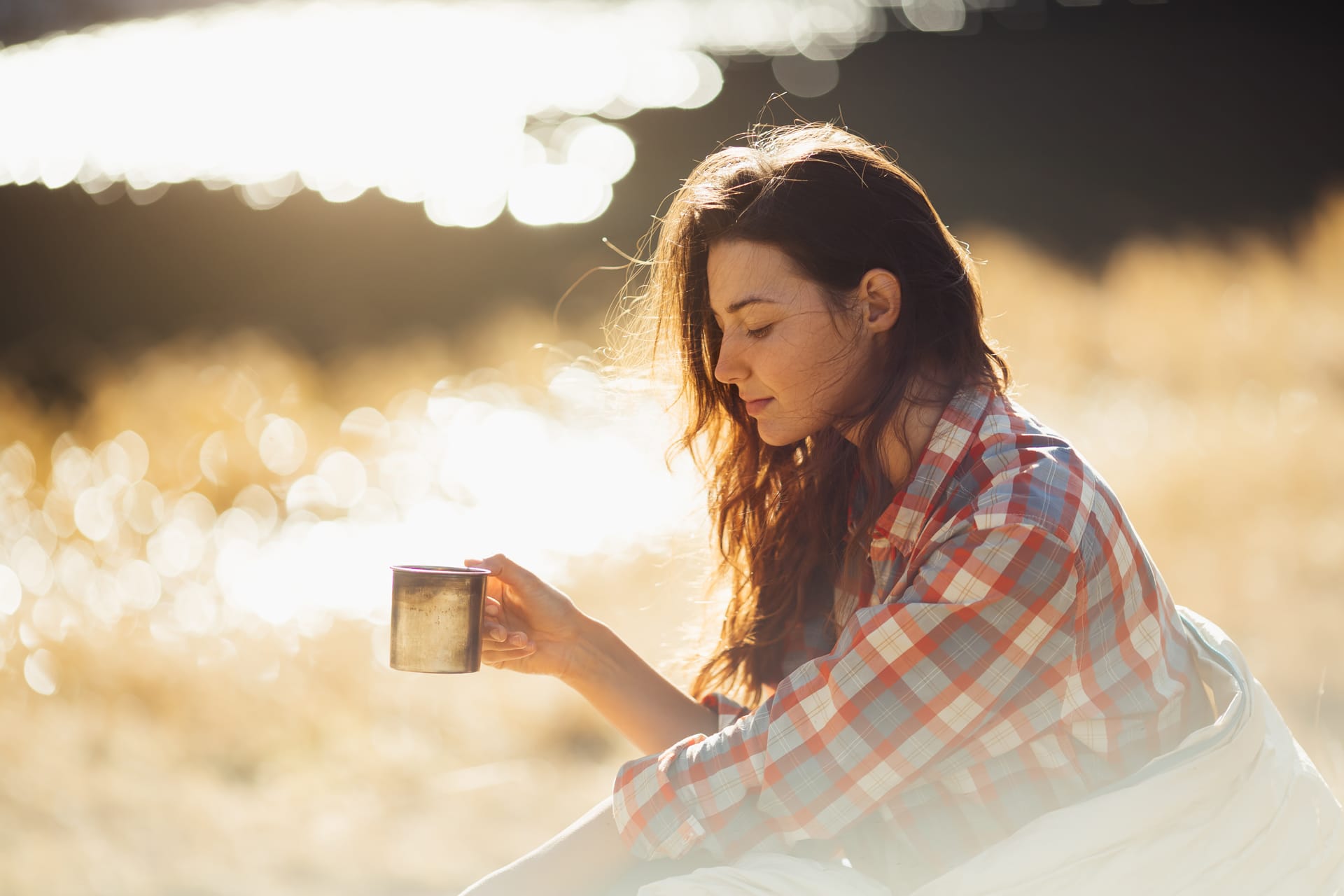 Traveler woman hiking mountains with cup coffee near lake