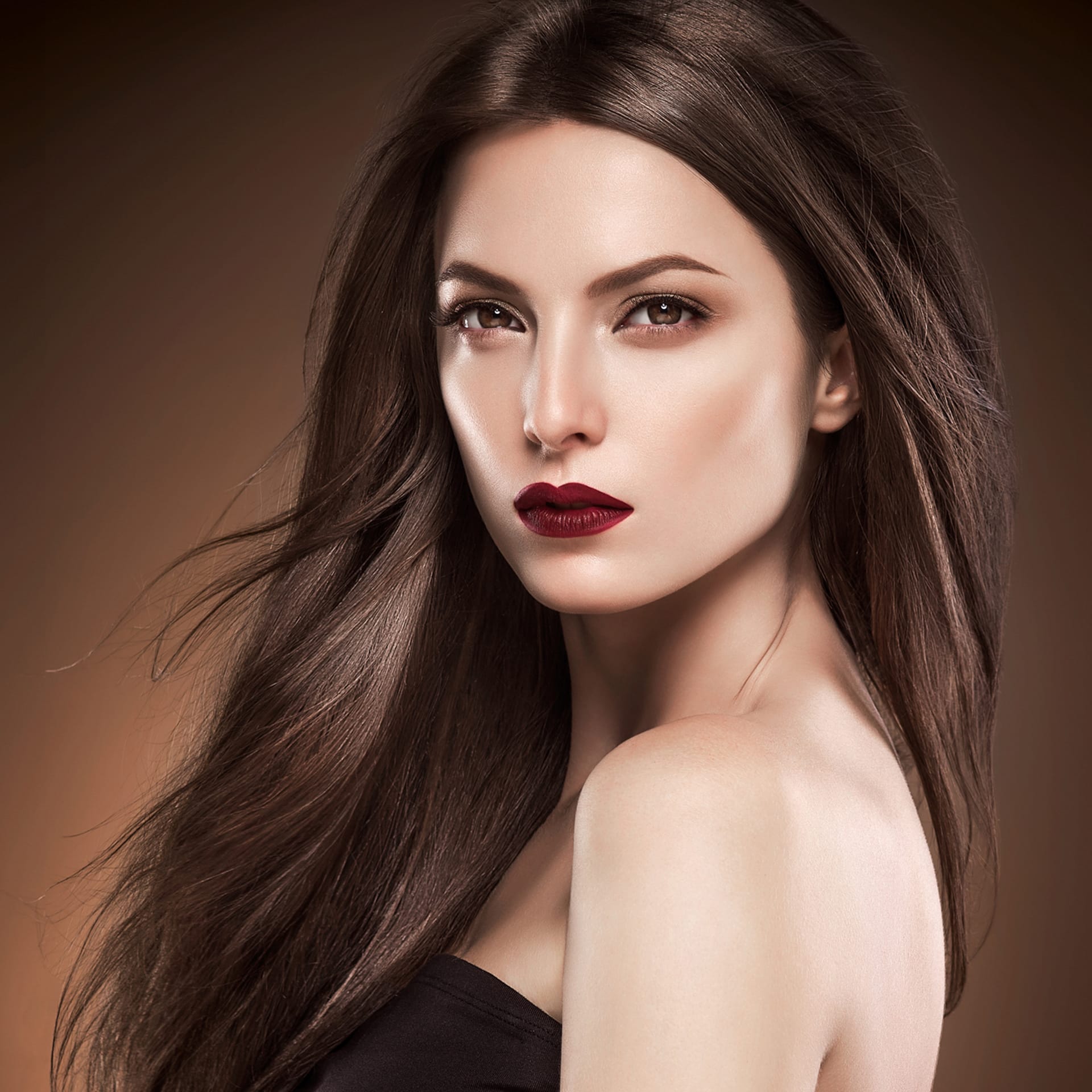 Beautiful manicure nails model red lipstick brown background evening makeup portrait studio shot