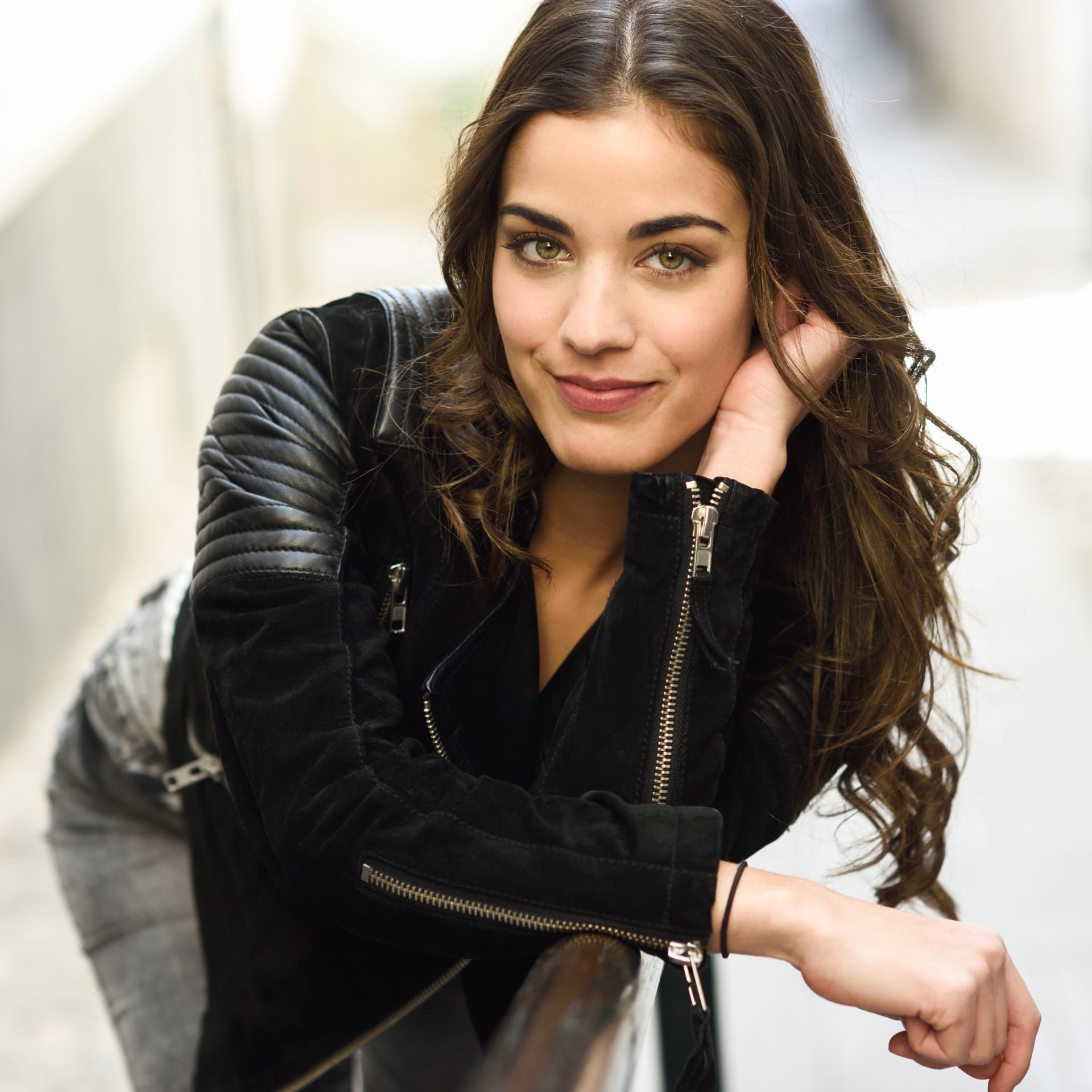 Close up smiling brunette woman with leather jacket