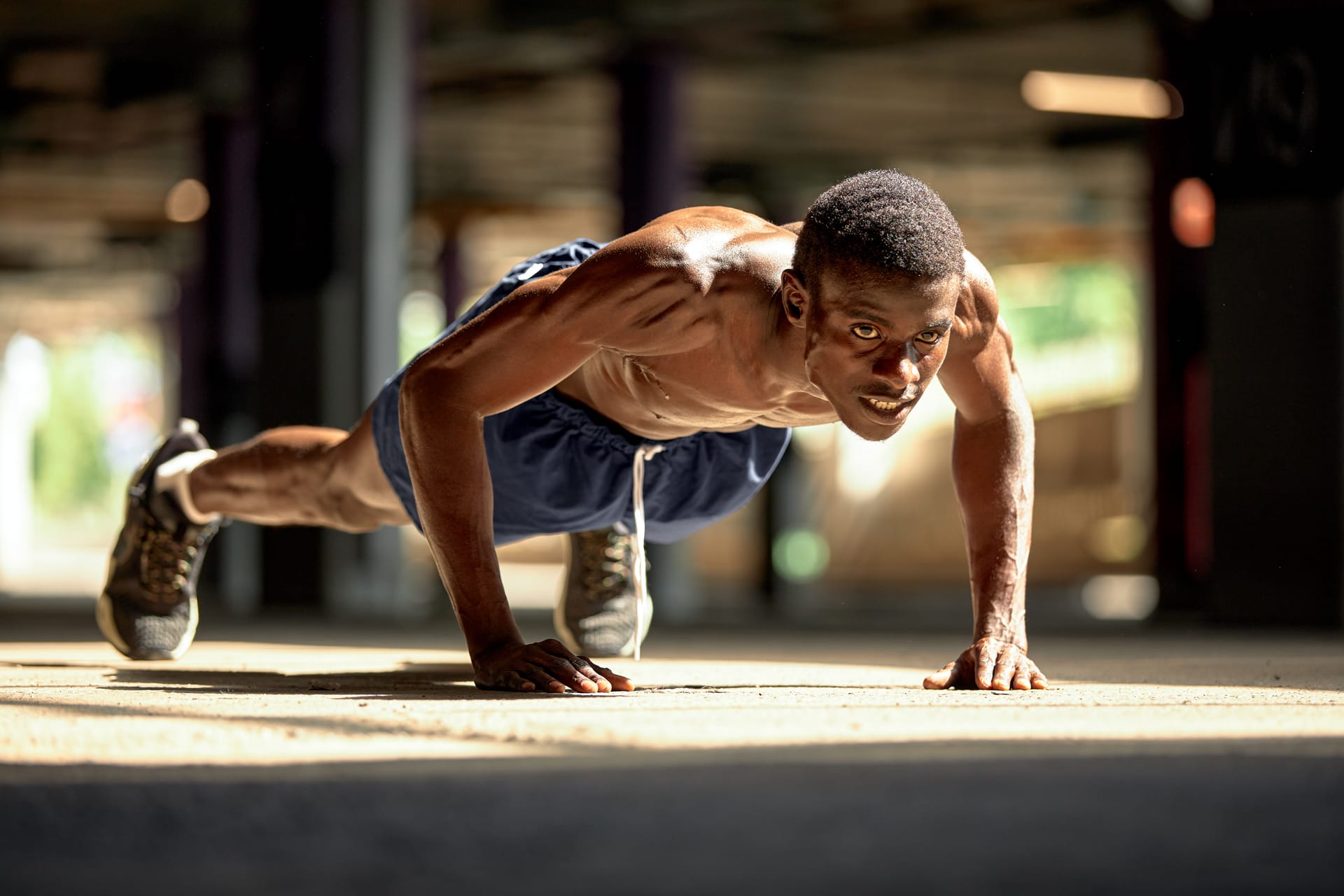 Push ups during workout street modern downtown with urban background