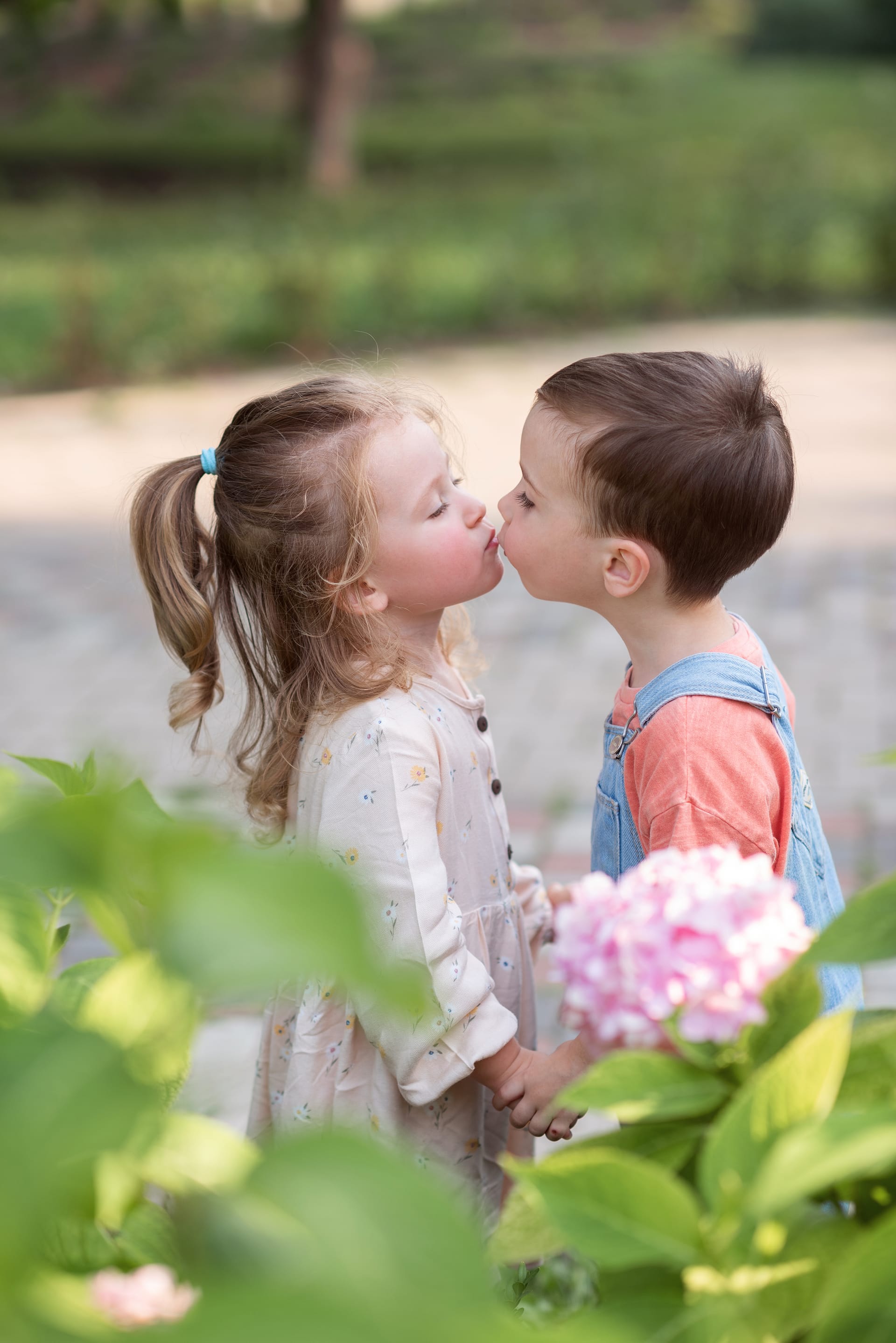 Little boy girl stand holding hands kiss valentines day image