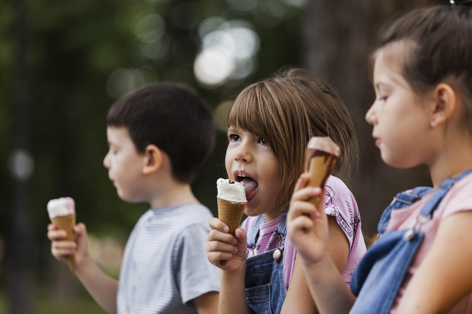 Young children enjoying ice cream outdoors