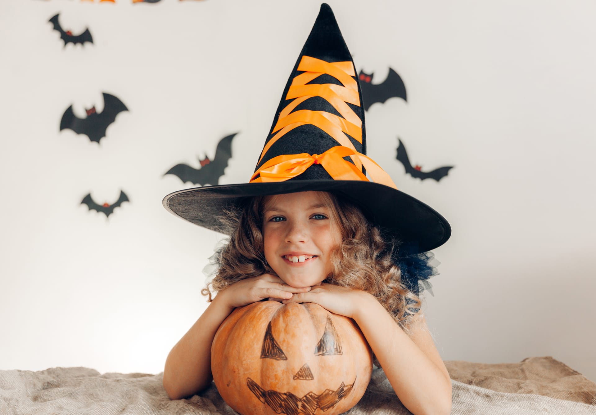 Little girl dressed as witch with pumpkin halloween pumpkin halloween