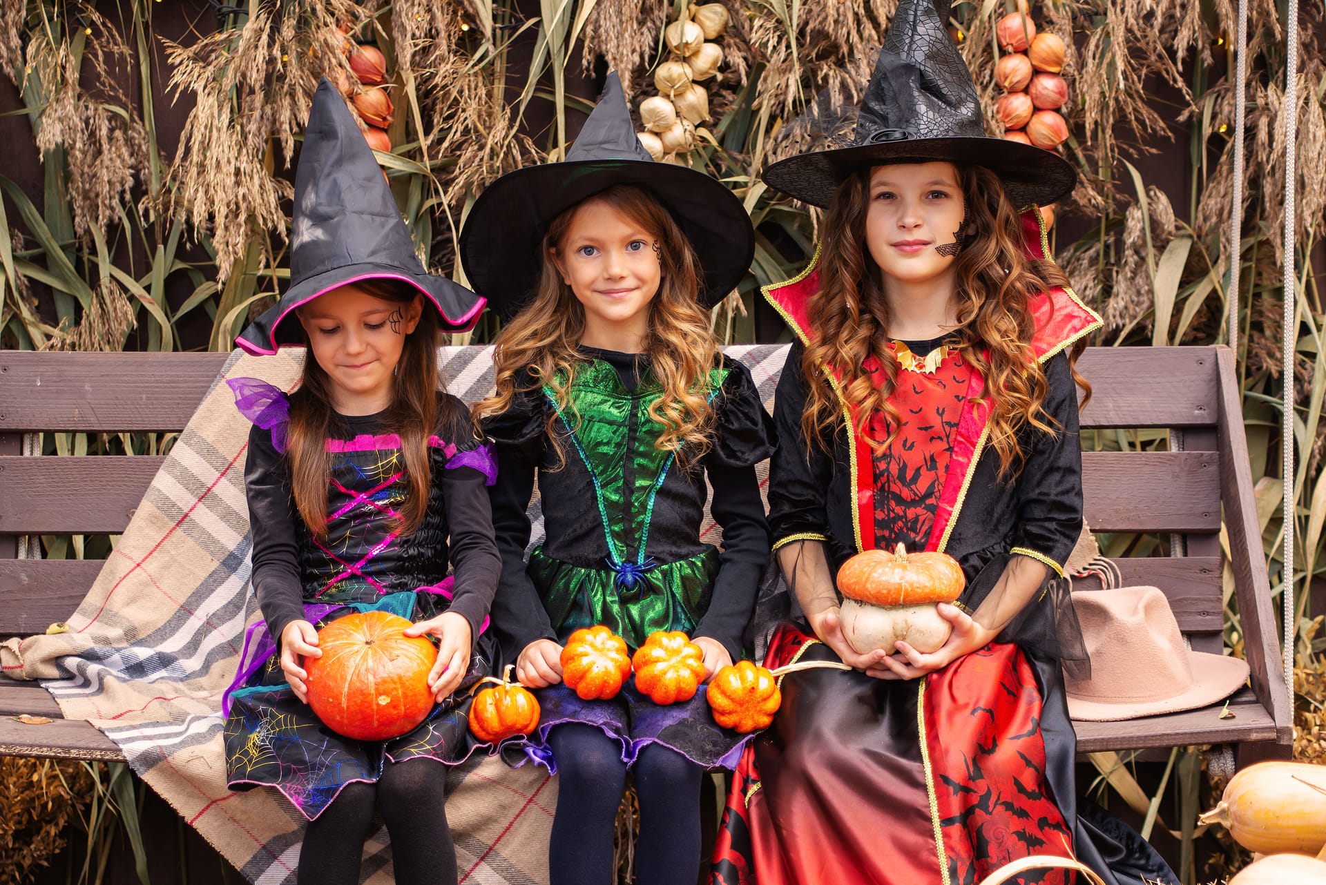 Three girls sisters witch costumes have fun celebrating halloween