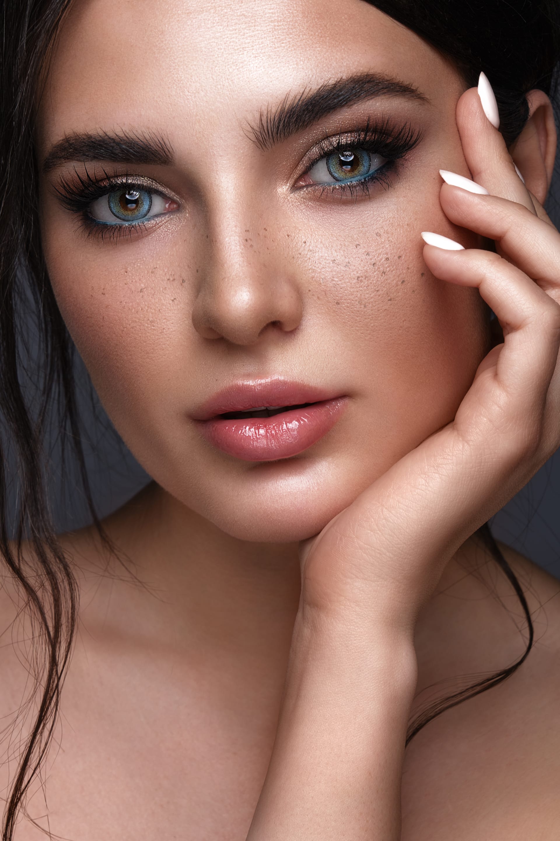Fashionable makeup freckles blue eyes beauty face photo taken studio