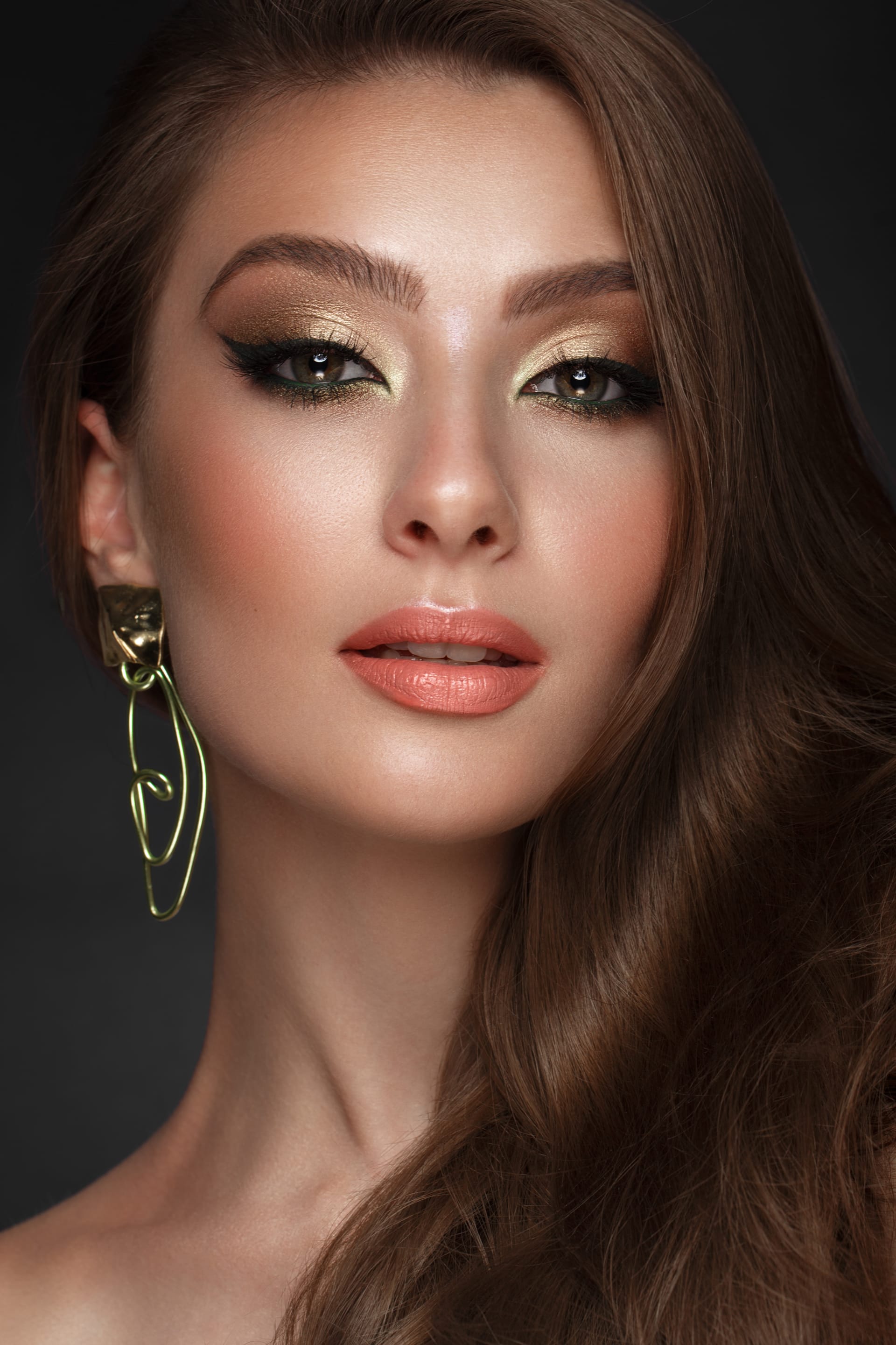 Fashionable makeup unusual gold accessories beauty face photo taken studio