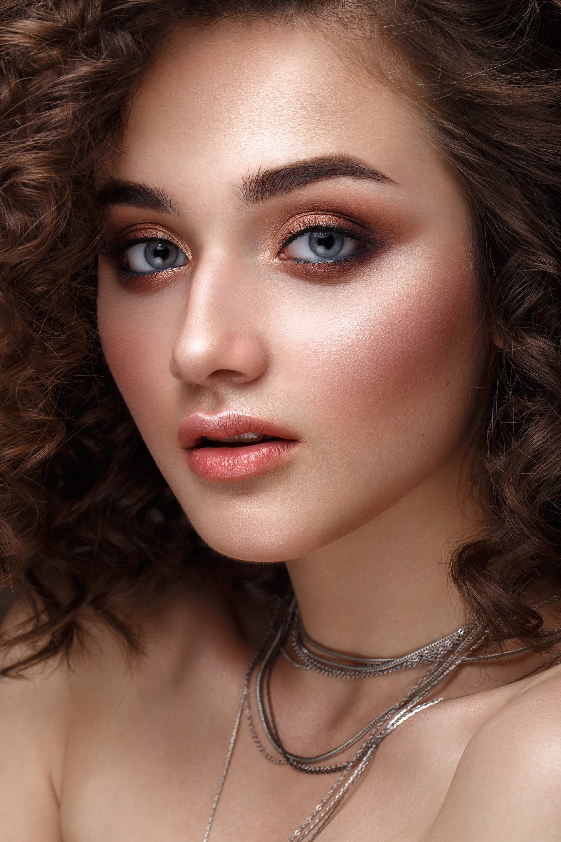 Girl with perfectly curly hair classic makeup beauty face image