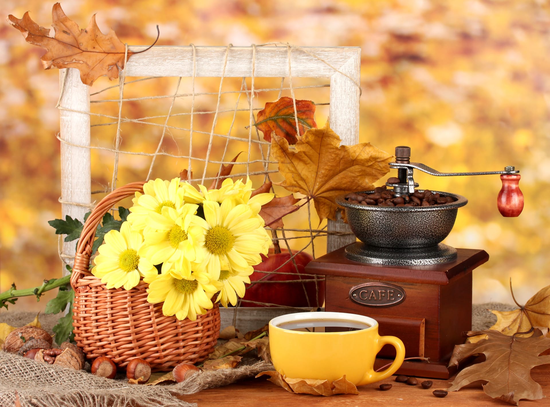 Autumnal compositioncoffee grinder flowers leaves bright background
