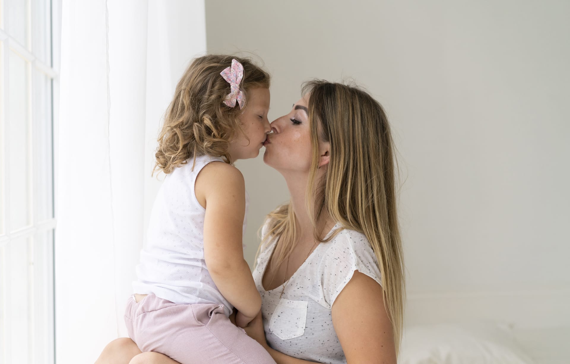 Medium shot mother daughter kissing mom images