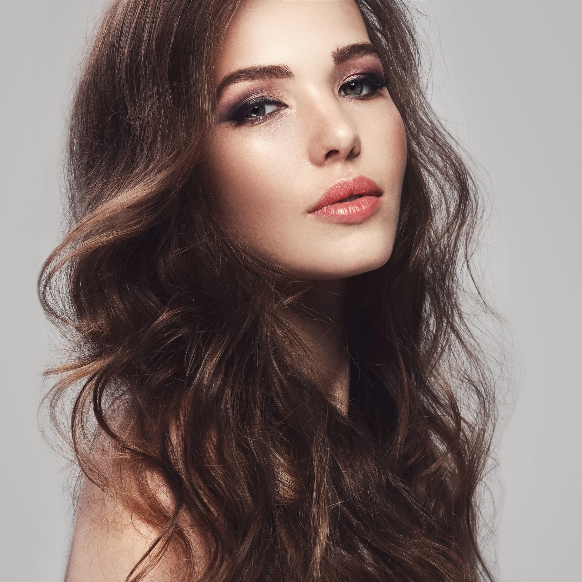 Beautiful young woman with long wavy hair