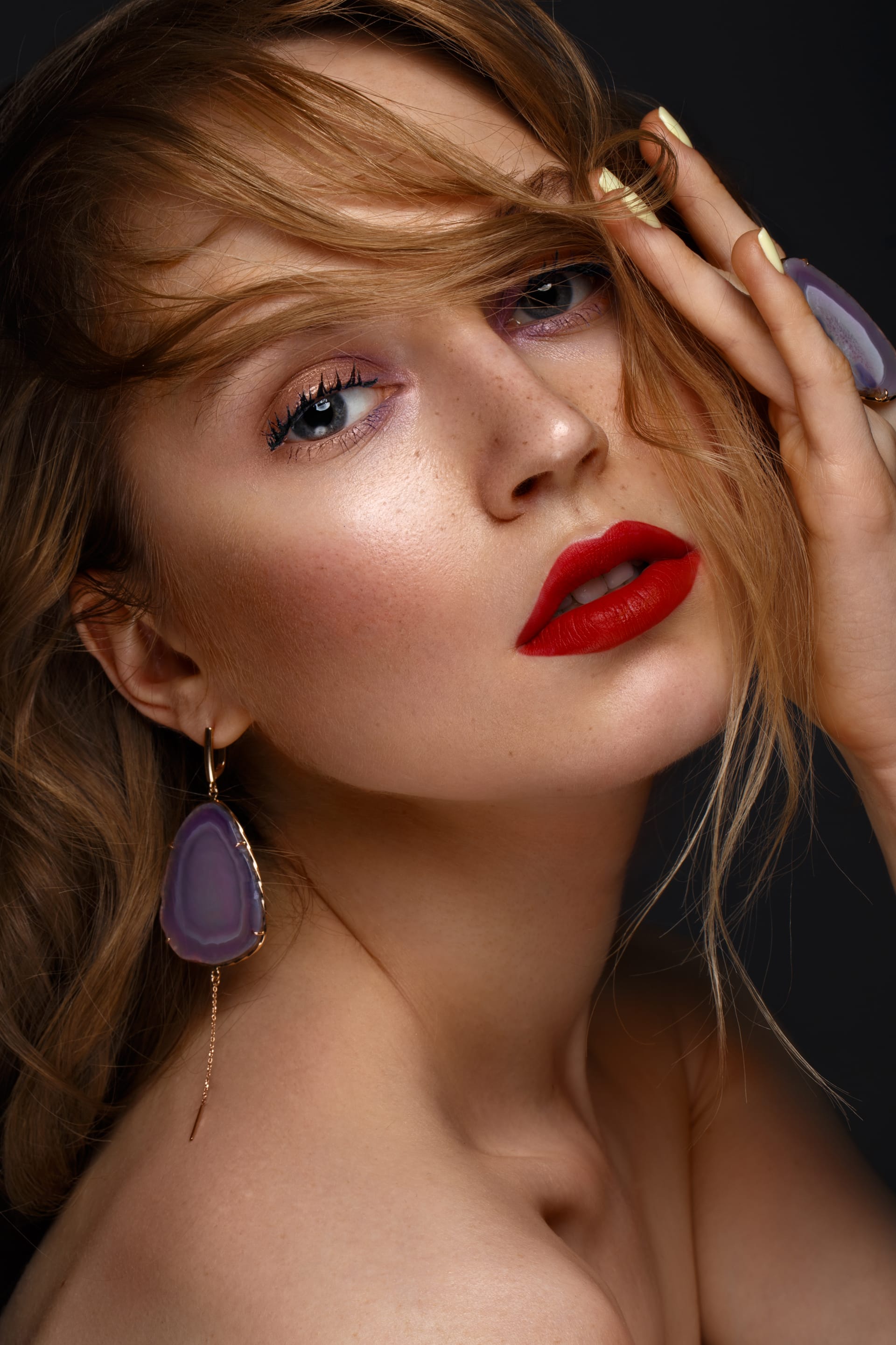Red lips classic makeup curls with large jewelry beauty face