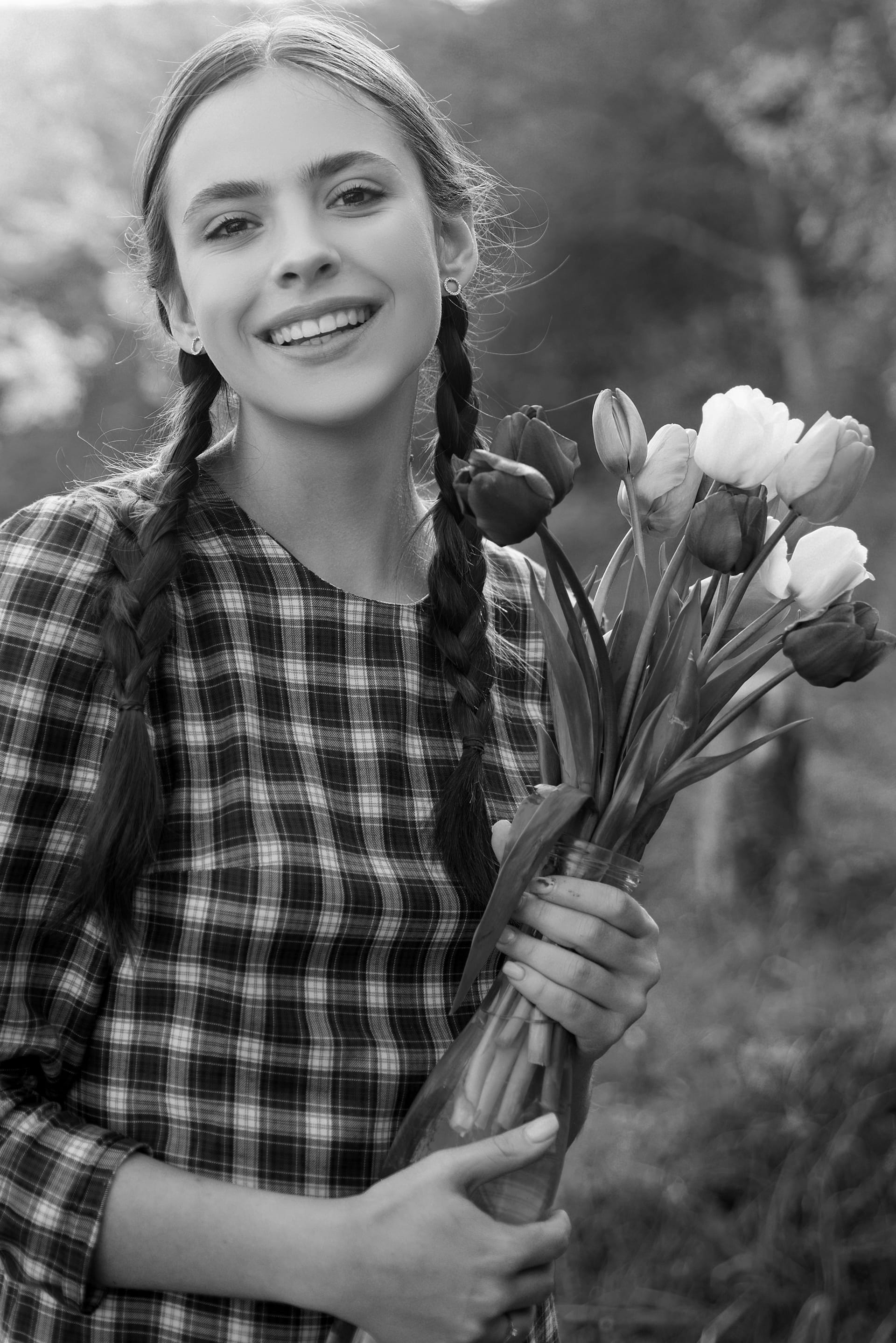 Happy beauty girl holding tulips garden pretty woman image