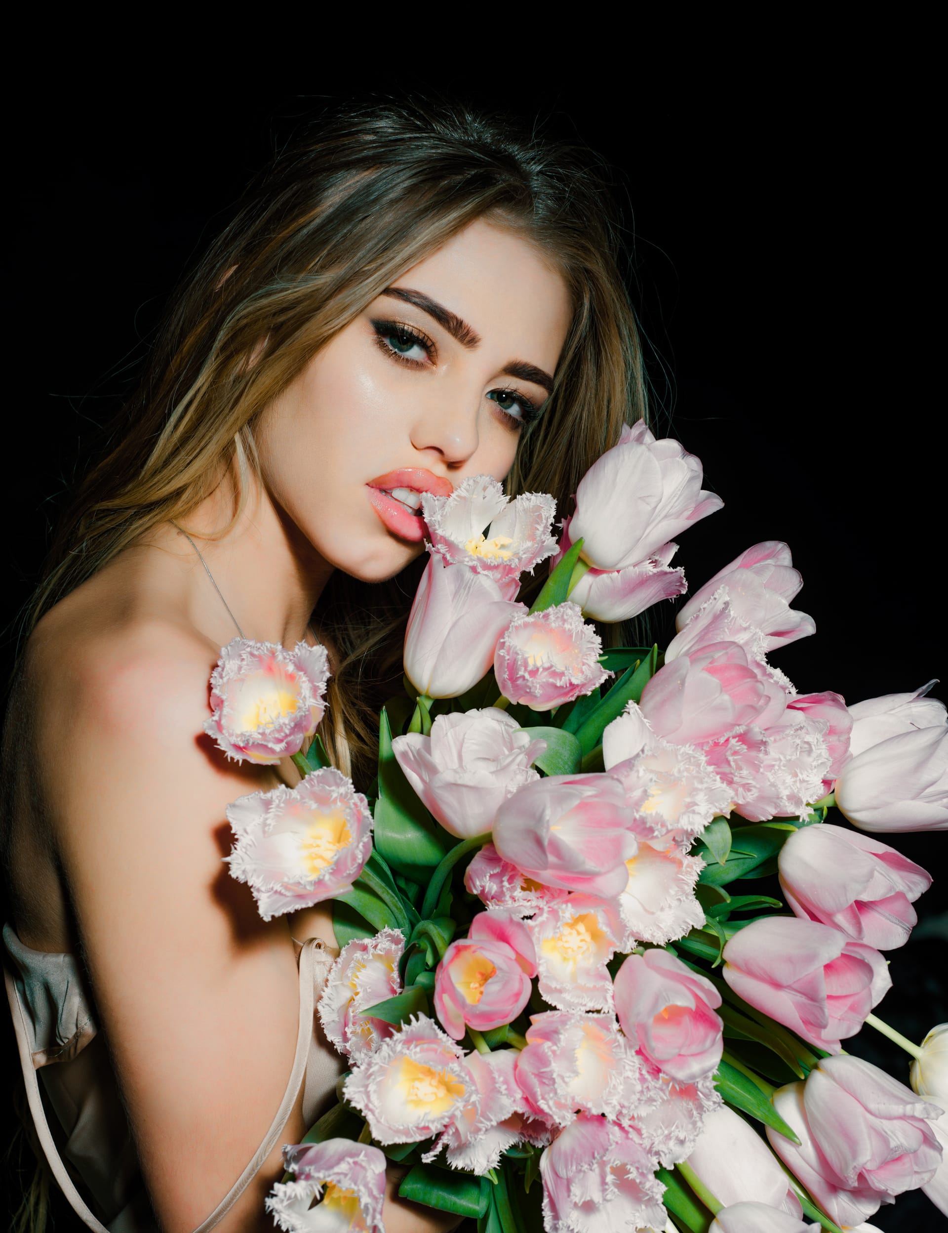 Sexy sensual young woman with tulips flowers bouquet spring woman black