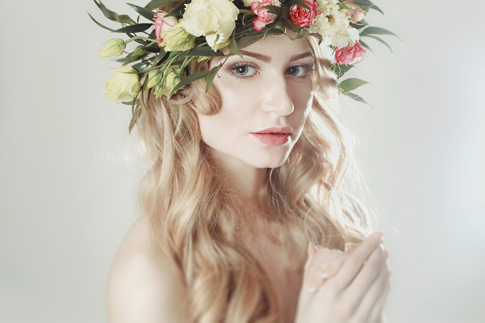 Girl with wreath flowers her head white background