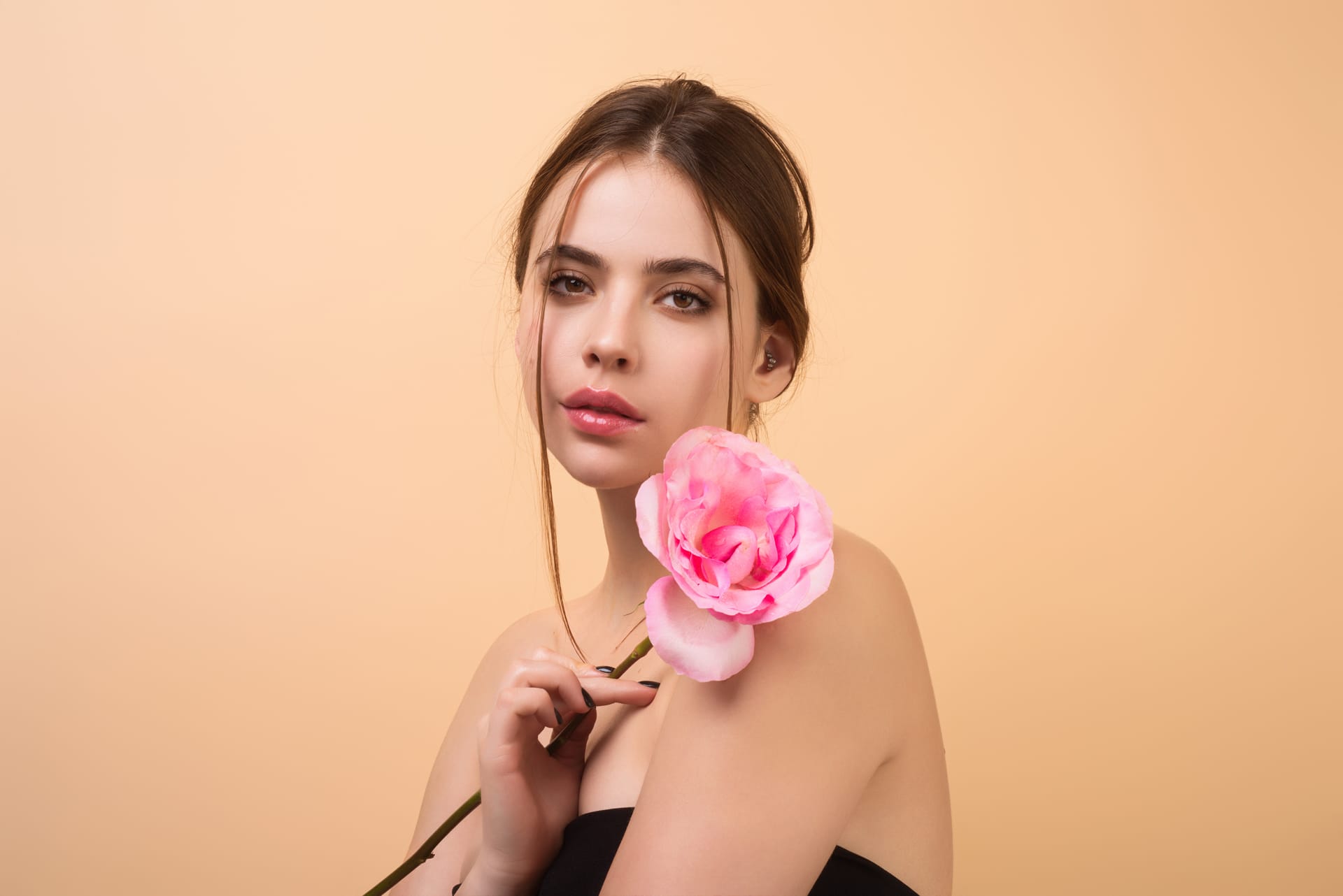 Portrait attractive lovely charming dreamy girl holding red roses isolated beige studio backgr