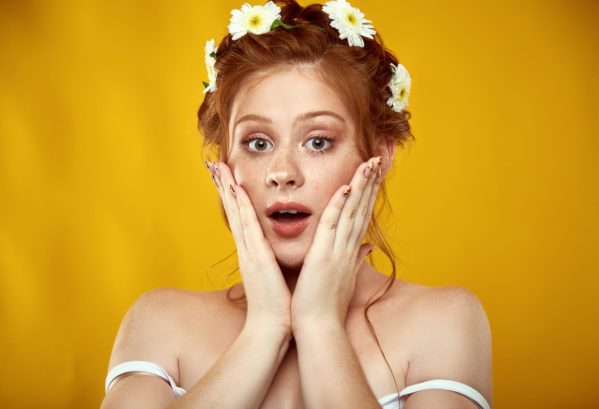 Beautiful positive redheaded girl with chamomile crown her head excellent image