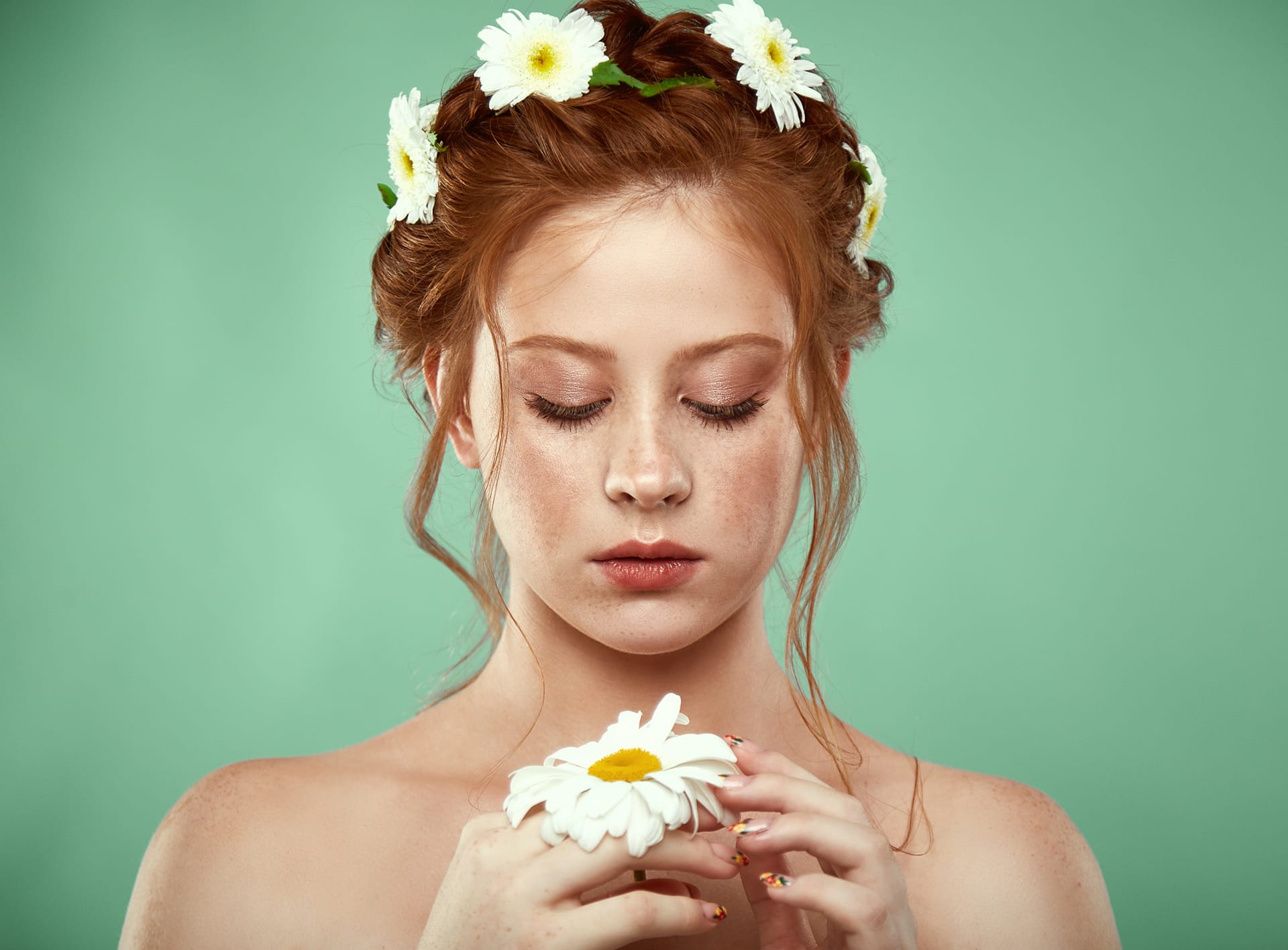Beautiful positive redheaded girl with chamomile crown her head excellent picture