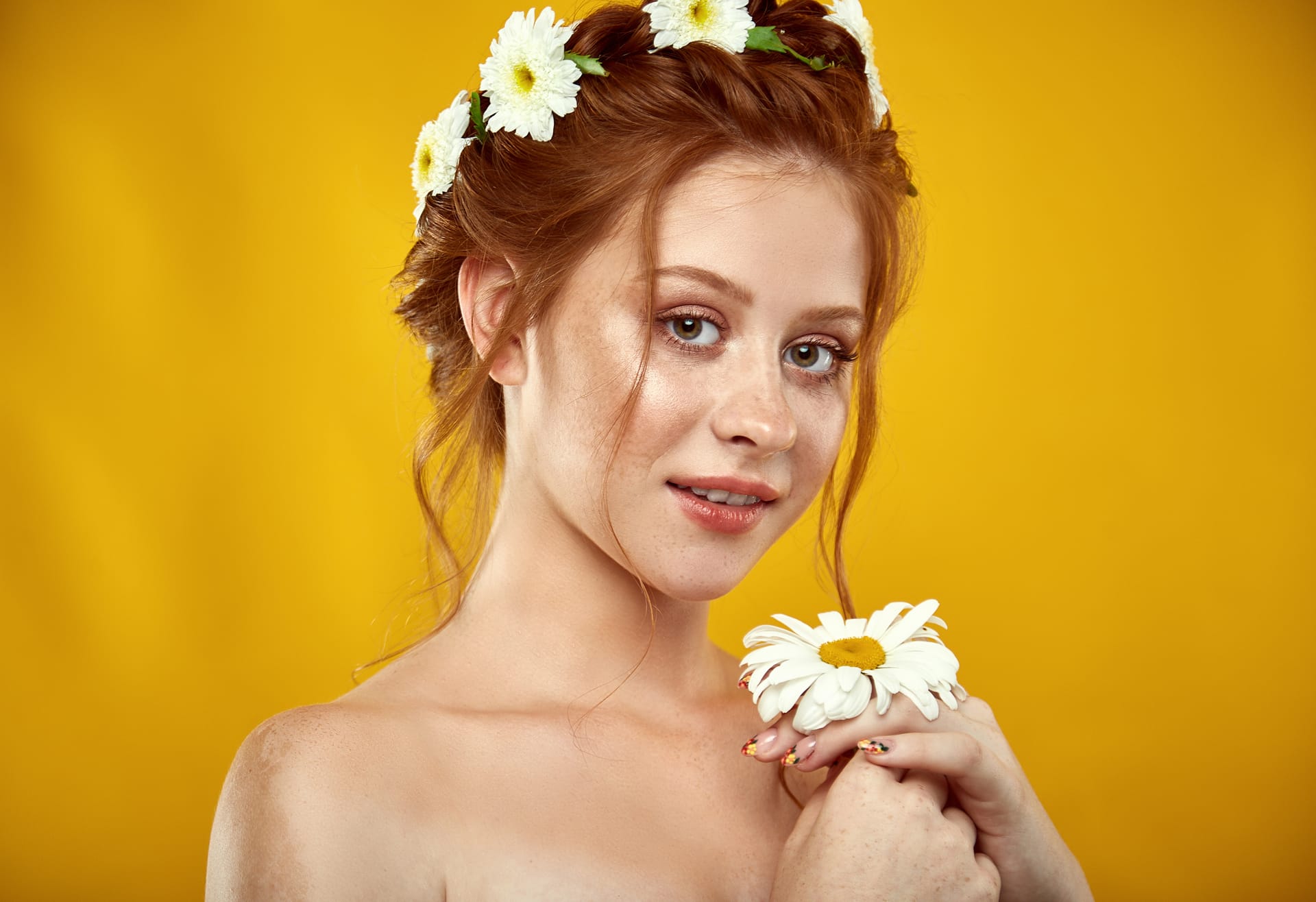 Beautiful positive redheaded girl with chamomile crown her head picture