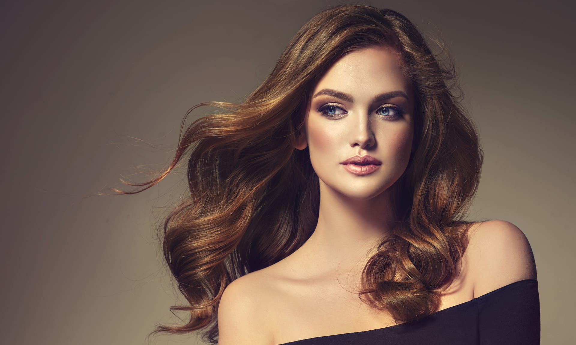 Model with long wavy well groomed hair hair care makeup flying hair