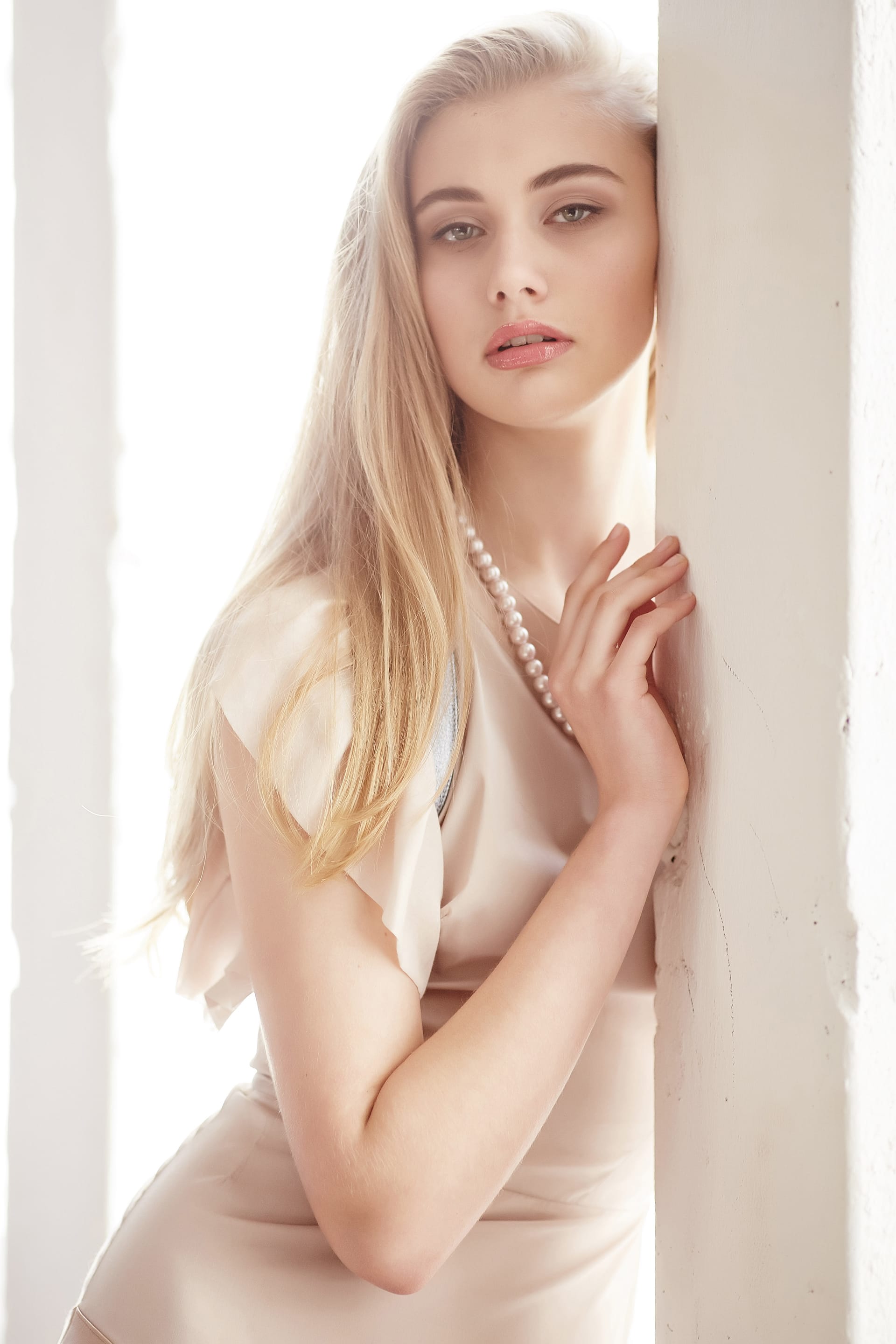 Slim female with long blond hair red lips