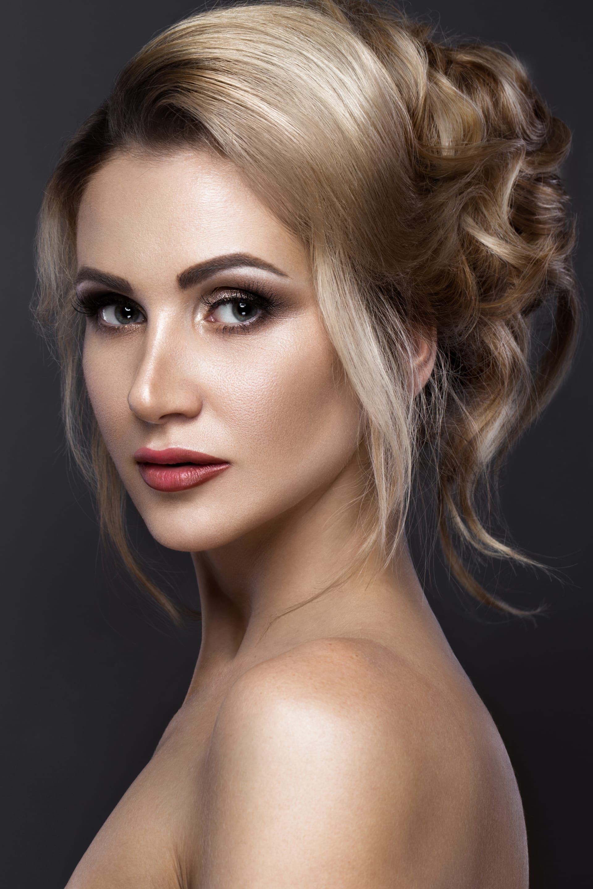 Woman with perfect skin evening make up wedding hairstyle
