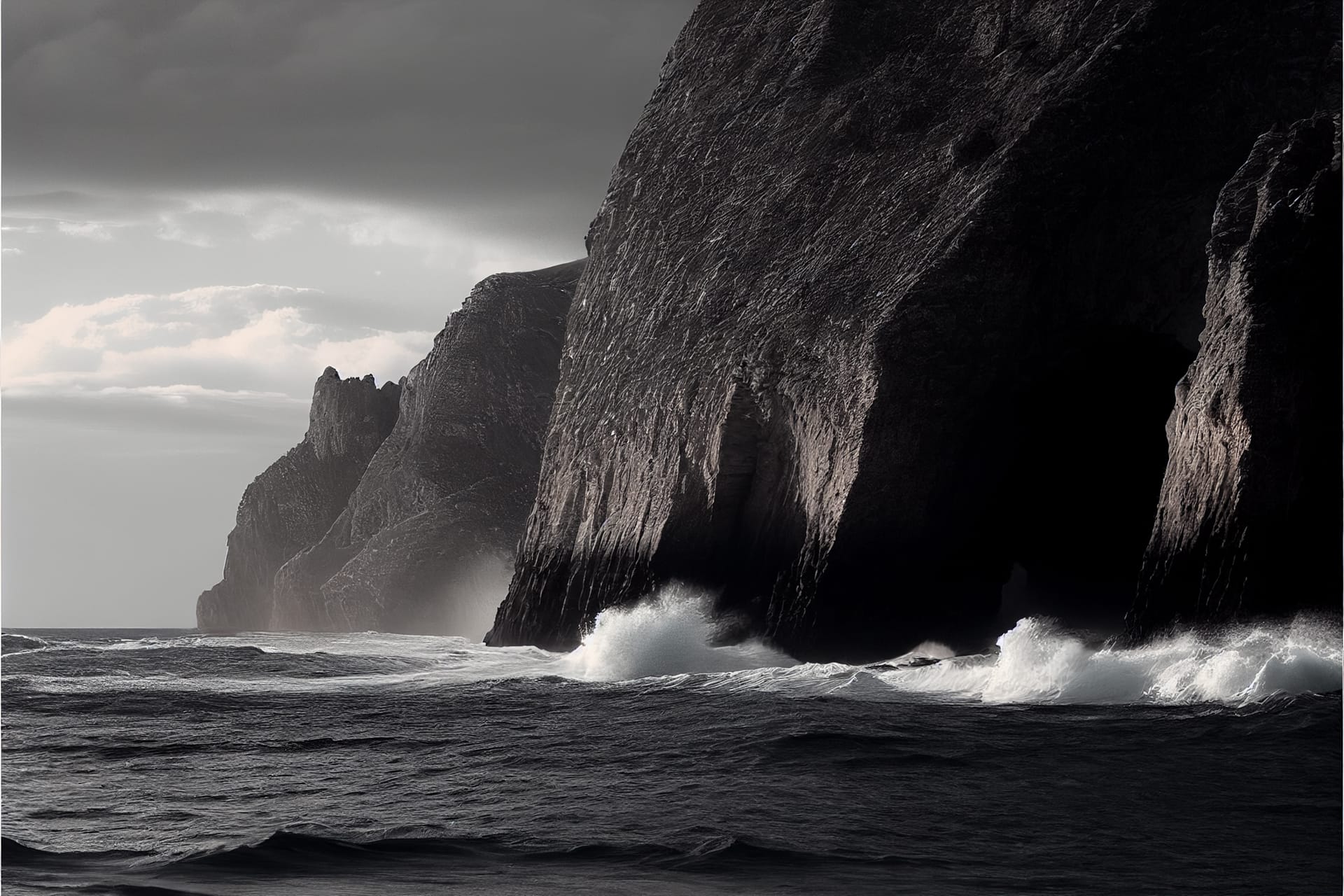Coastal landscape with high cliffs crashing waves from edge edge