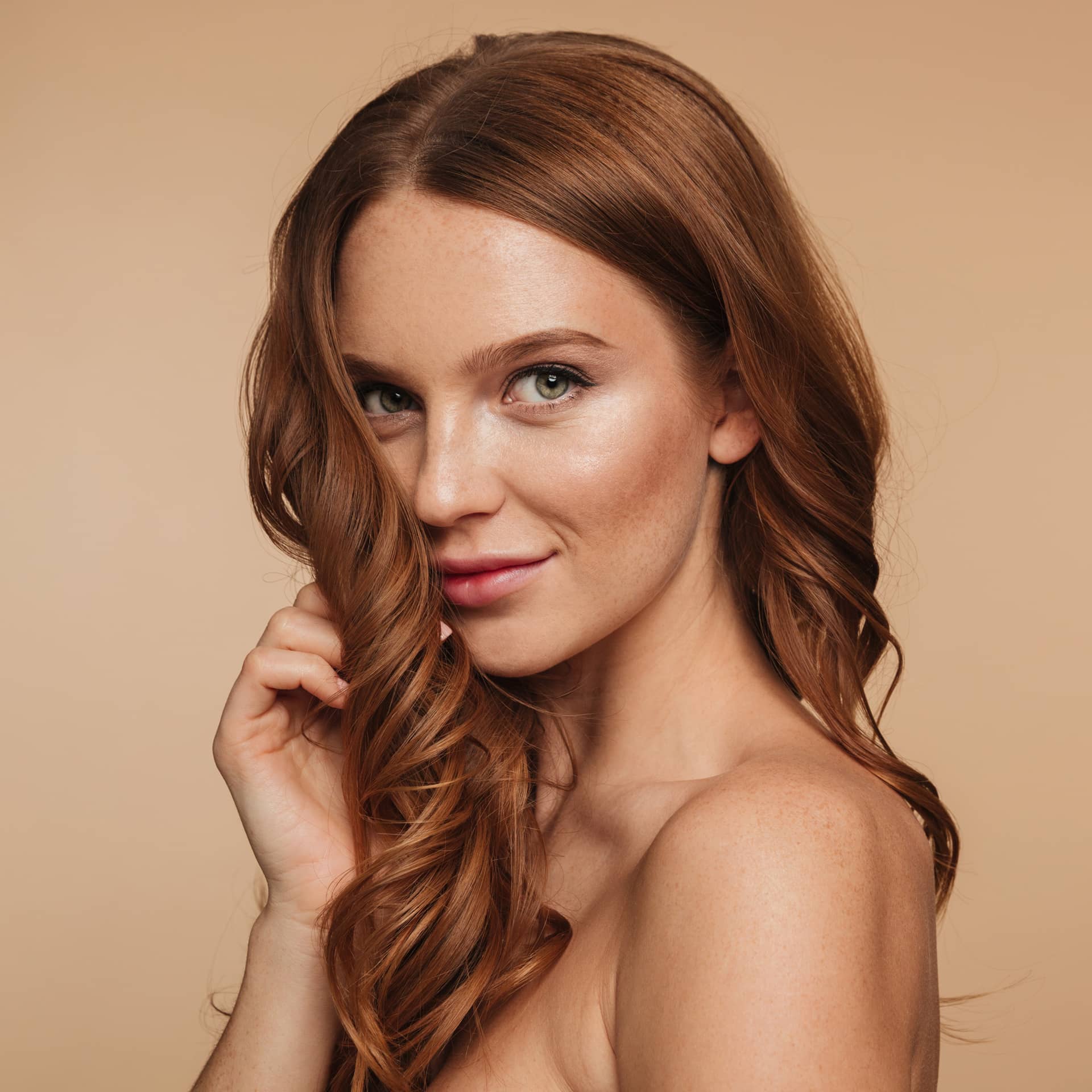 Mystery smiling ginger woman with long hair posing sideways looking