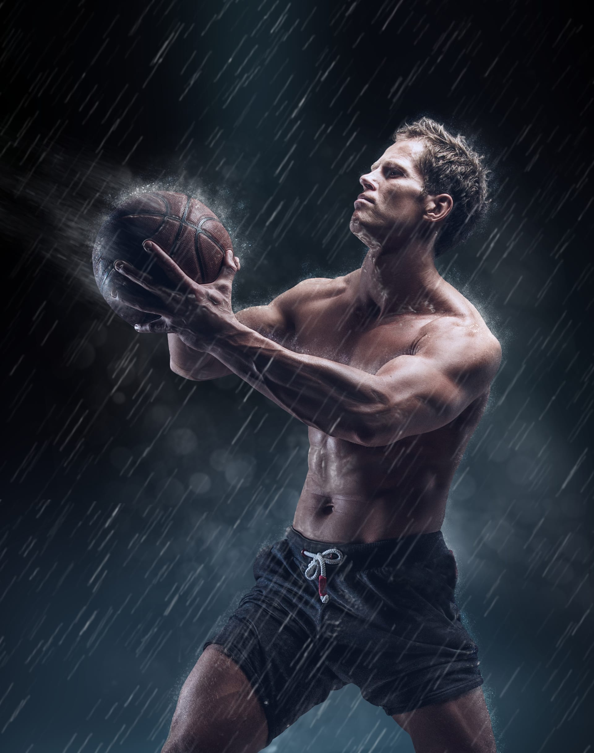 Artistic portrait shirtless wet bascetball player droplets image