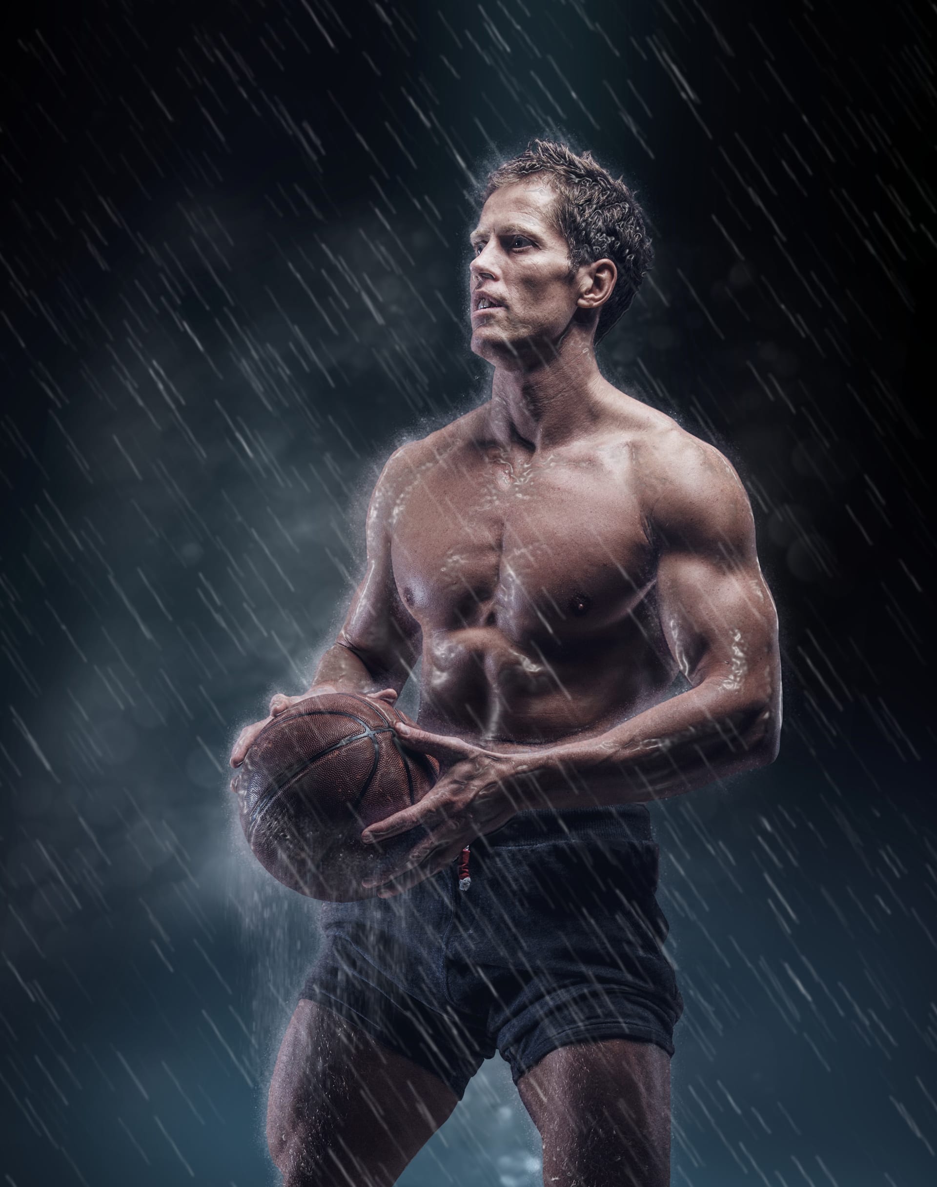 Artistic portrait shirtless wet bascetball player droplets