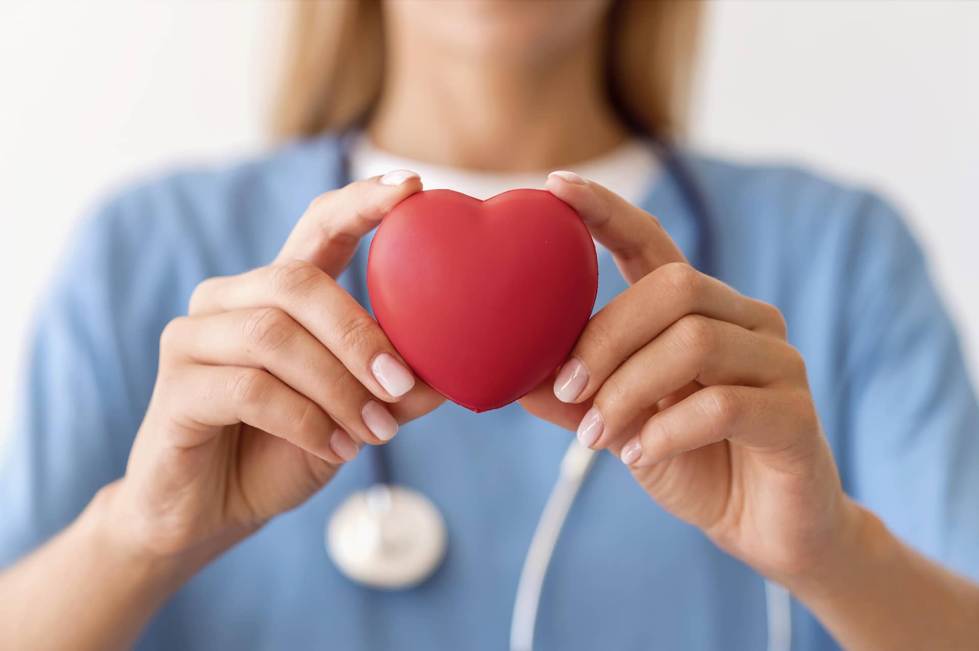 Defocused female doctor holding heart profile picture
