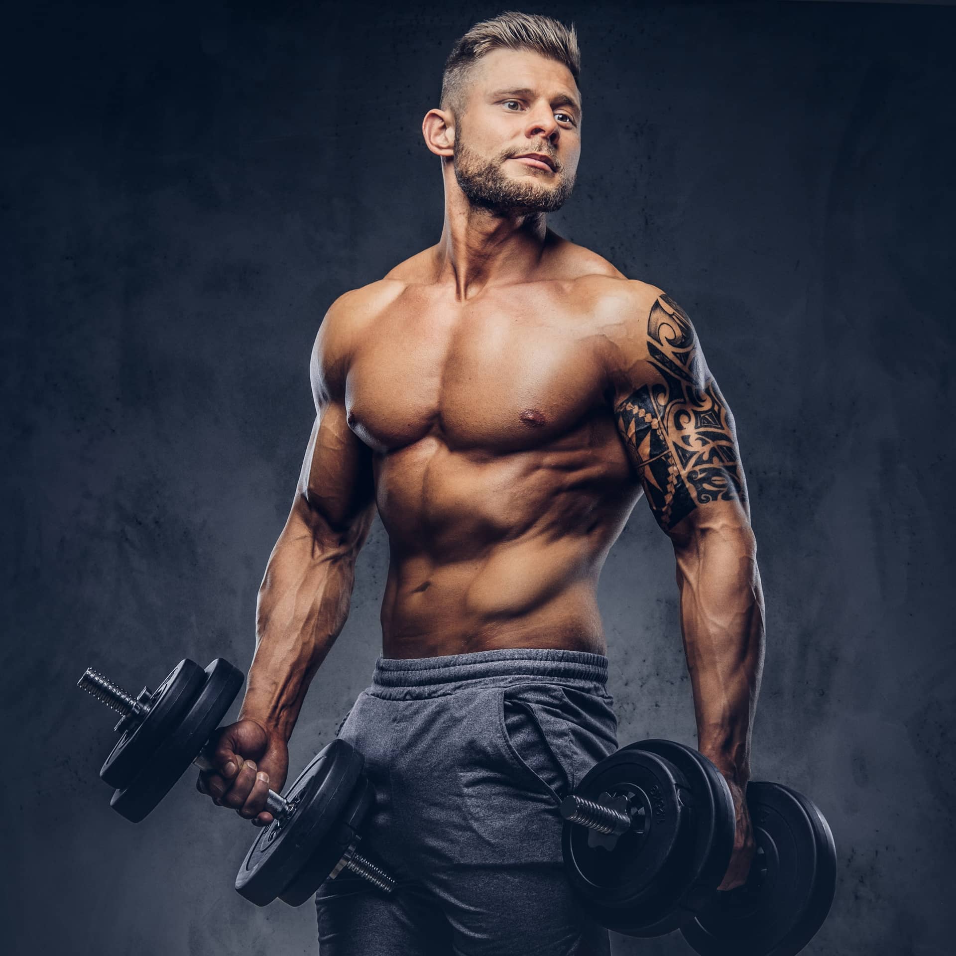 Tattoo his arm doing exercises with dumbbells isolated dark background artist creation
