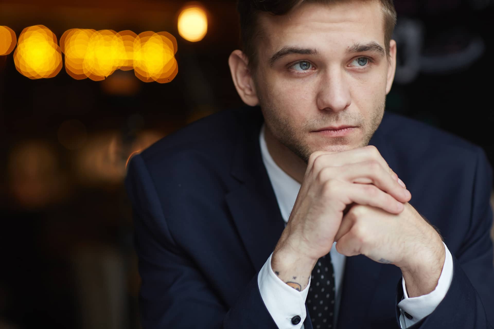 Young pensive businessman cafe