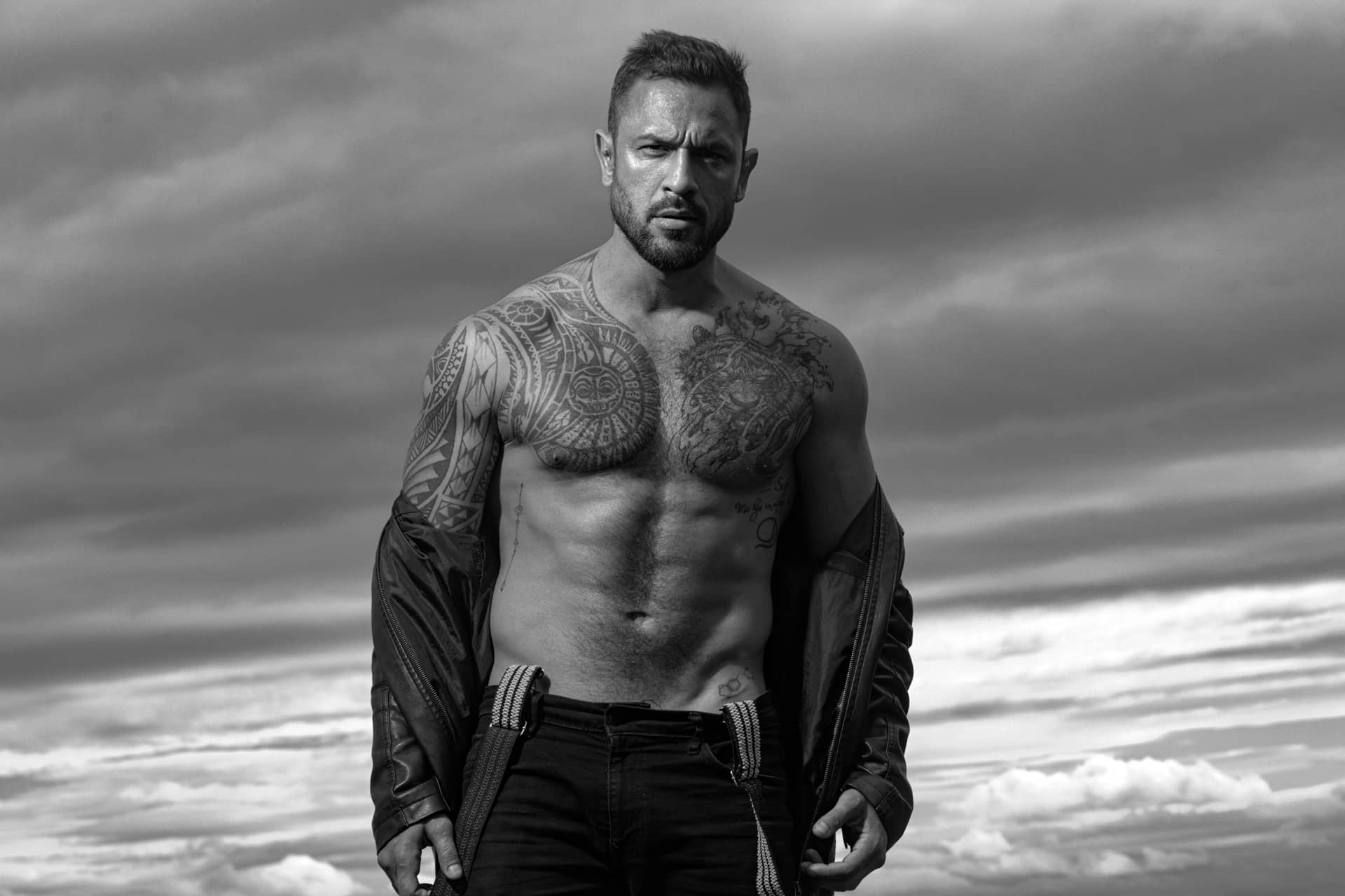 Shoulders topless athletic body fashion male model with leather jacket