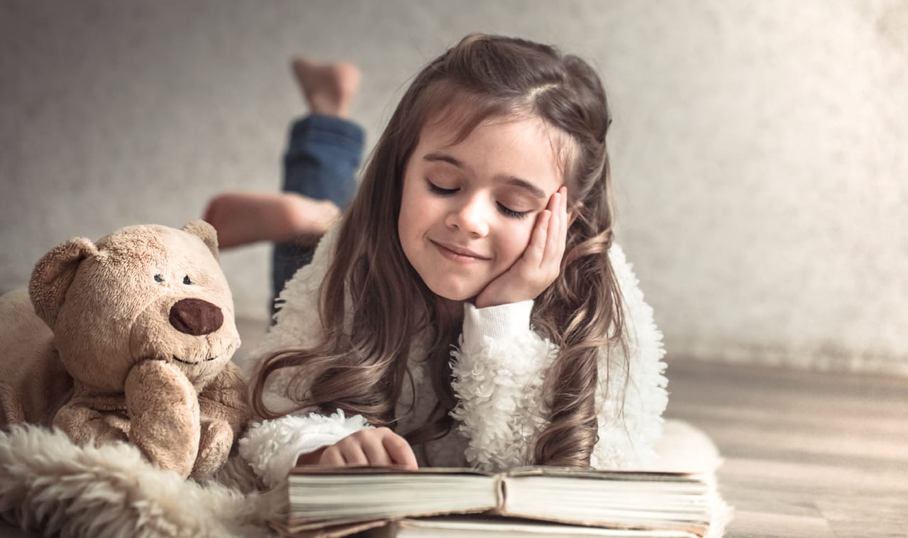 Related image little girl reading book with teddy bear floor concept relaxation friendship