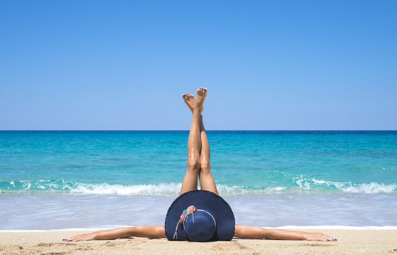 Related image woman lying beach with legs up air