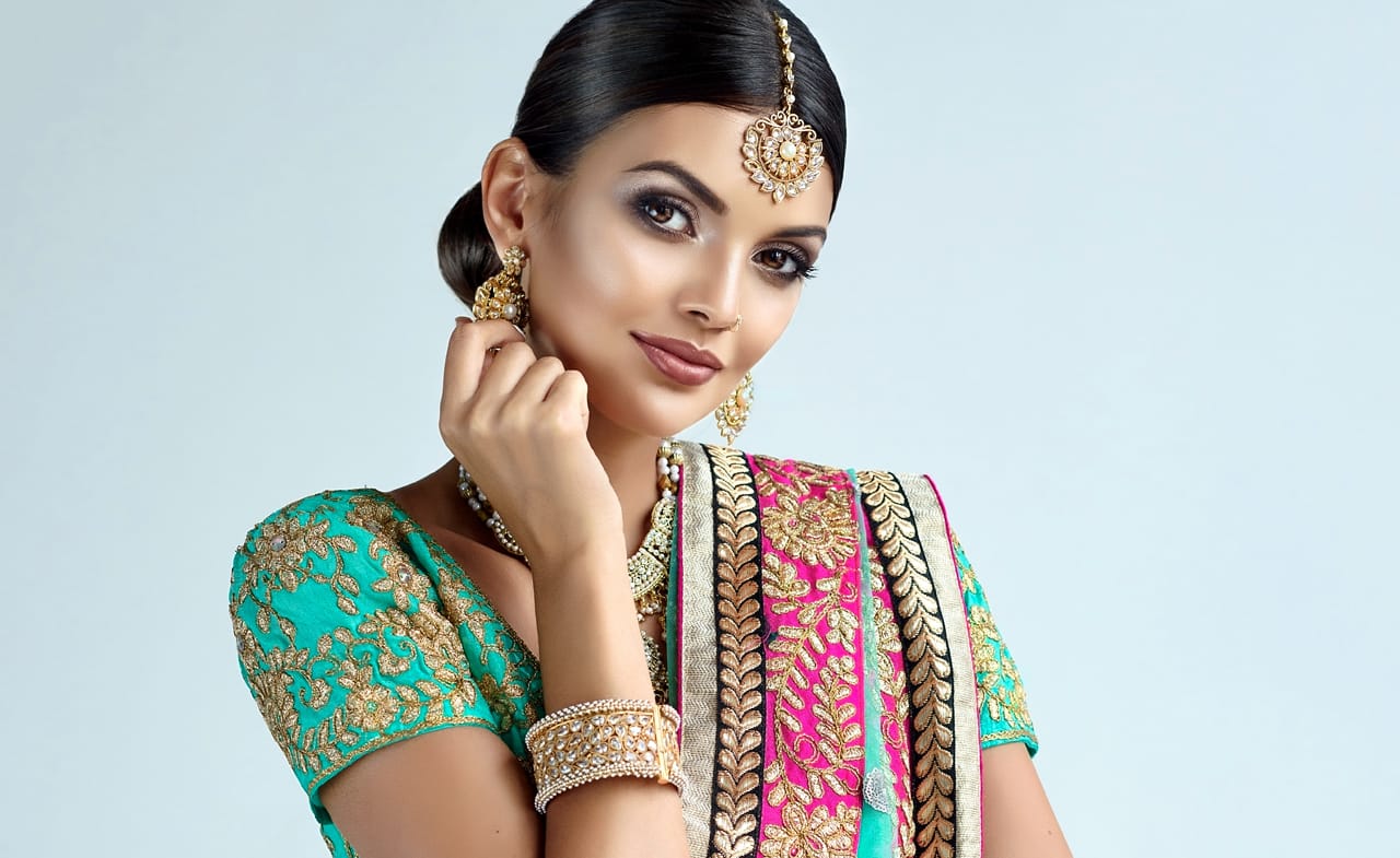 Related image smiling black eyed woman wearing splendid makeup indian jewelry set with head tikka