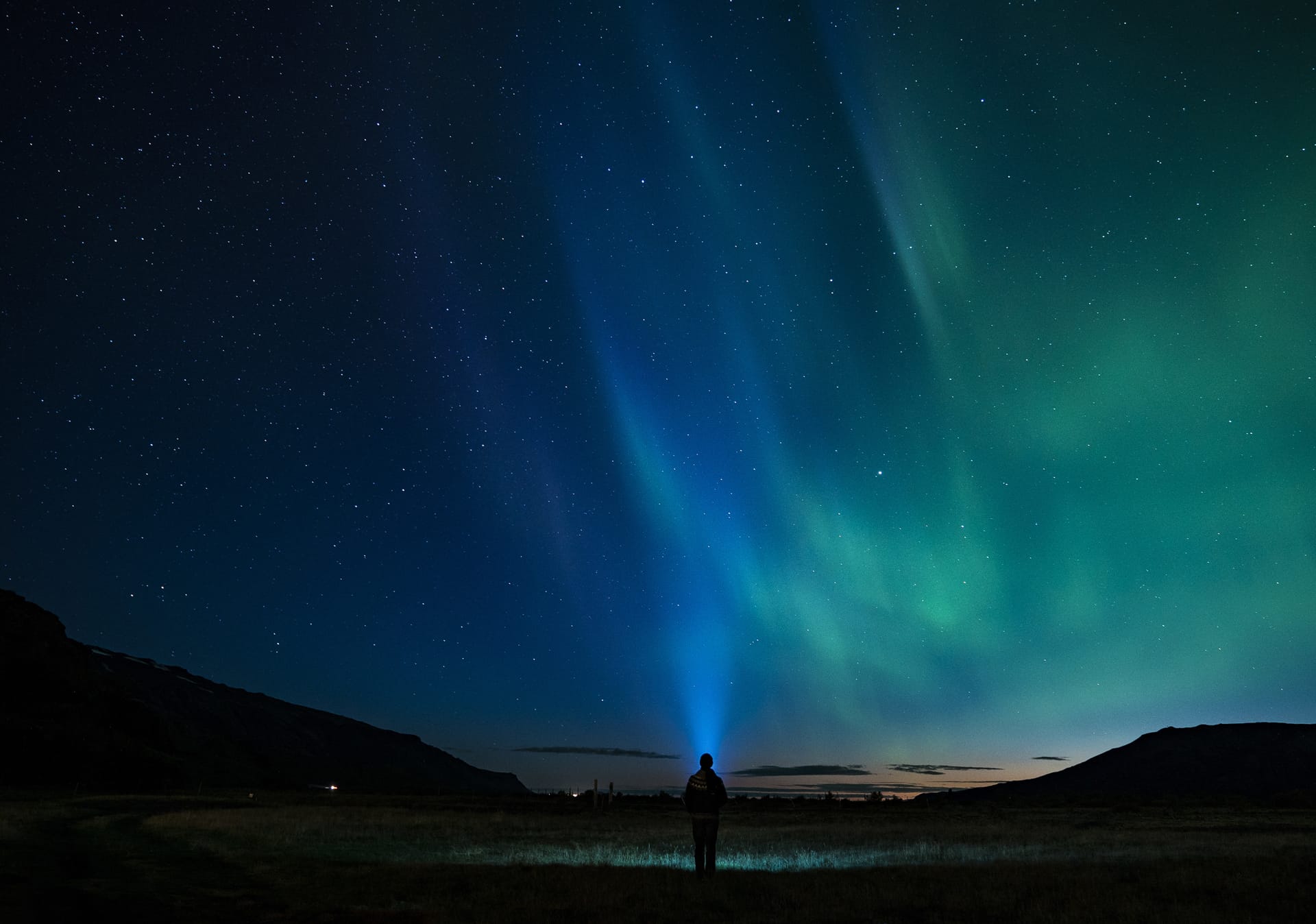 Silhouette person standing aurora night sky