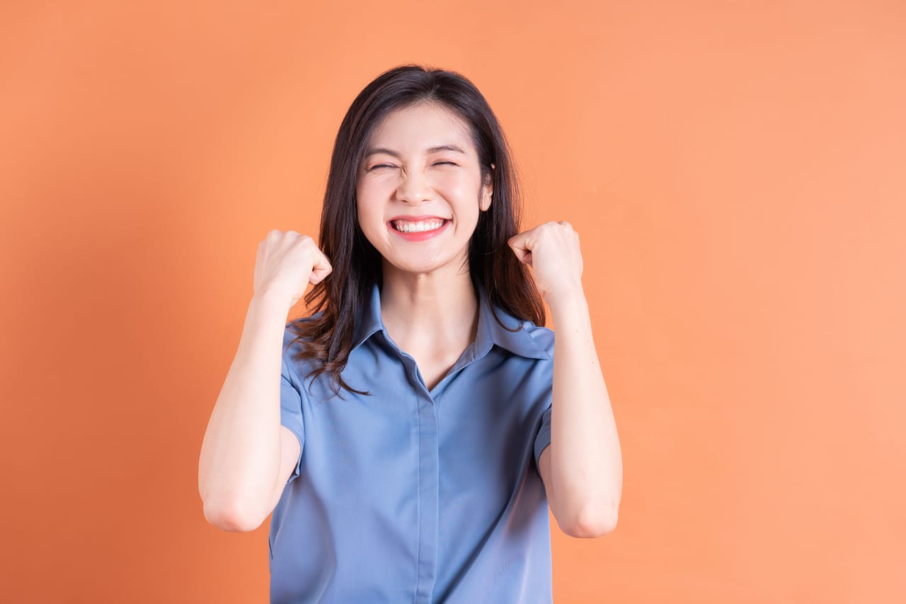 Related image young asian business woman posing orange background