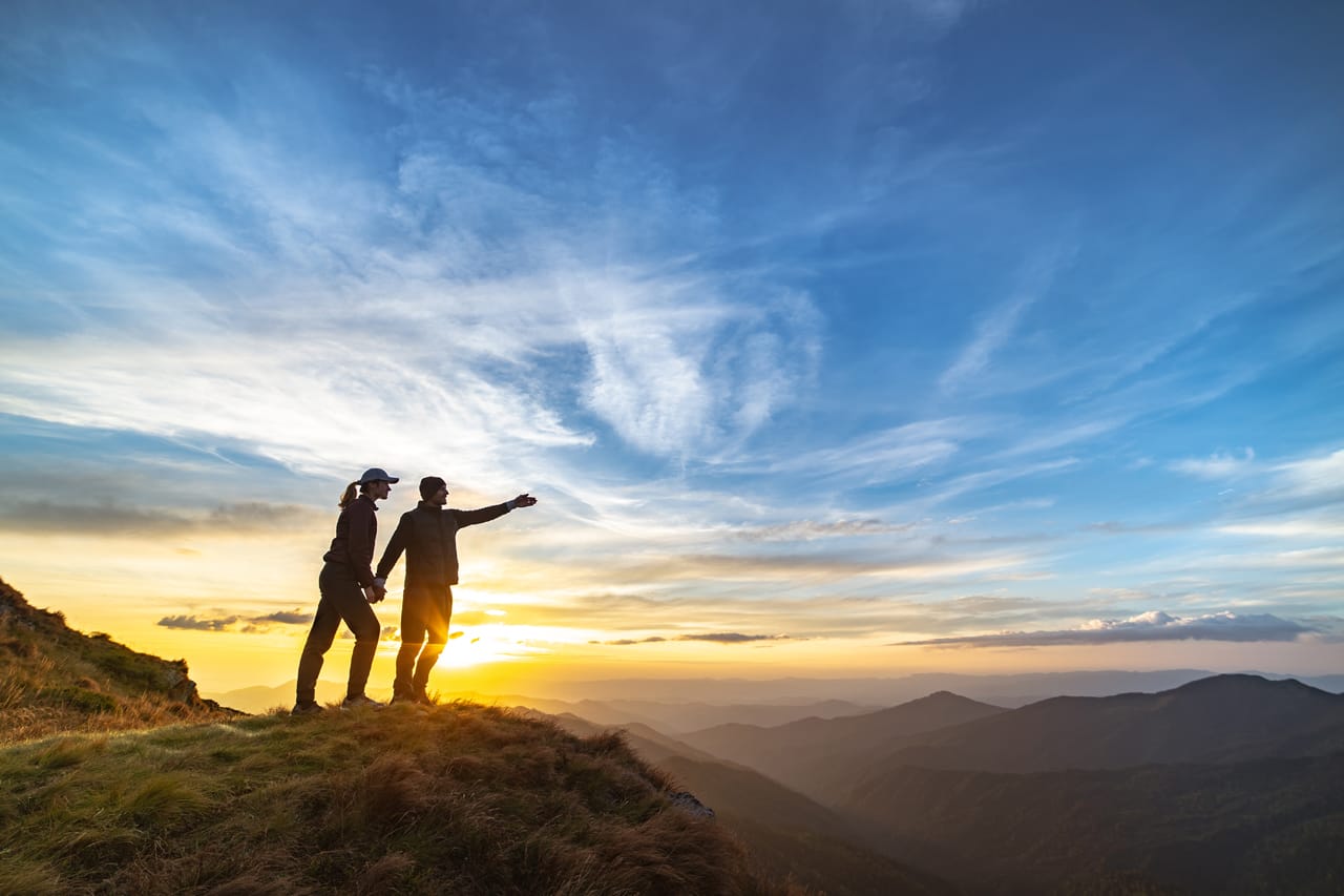 Related image couple gesturing mountain with picturesque sunset