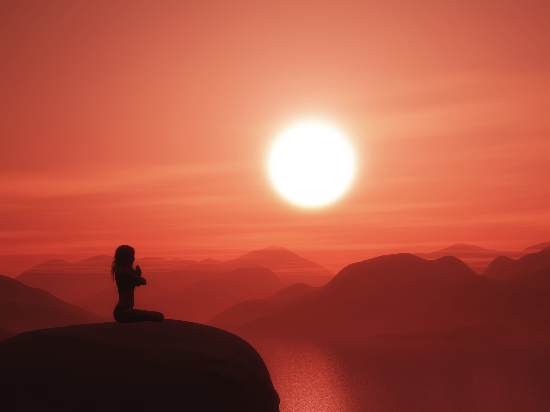 Female yoga pose against sunset landscape